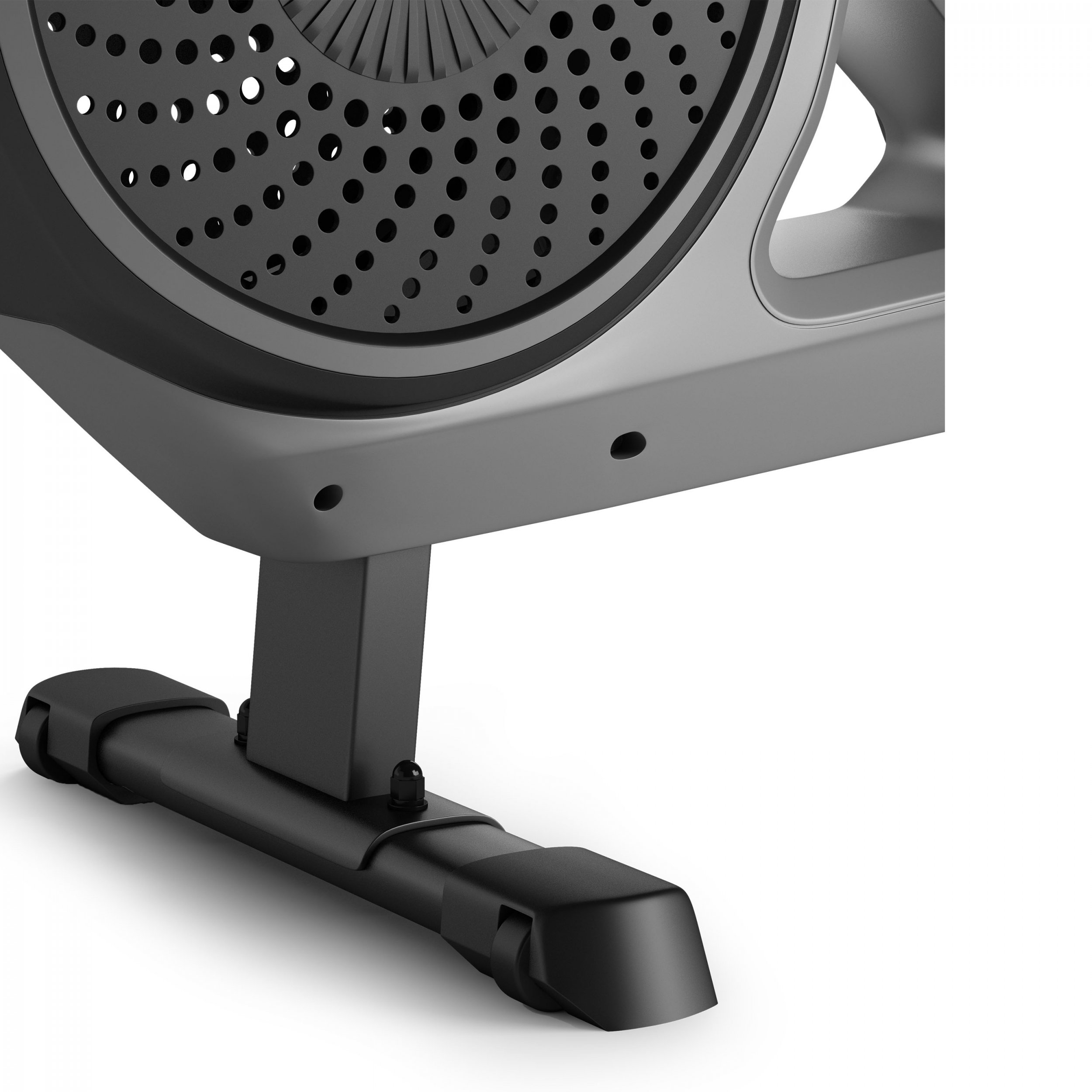 Close-up van een basis en wiel van een fitnessapparaat. Het heeft een zwarte basis en een grijze behuizing.