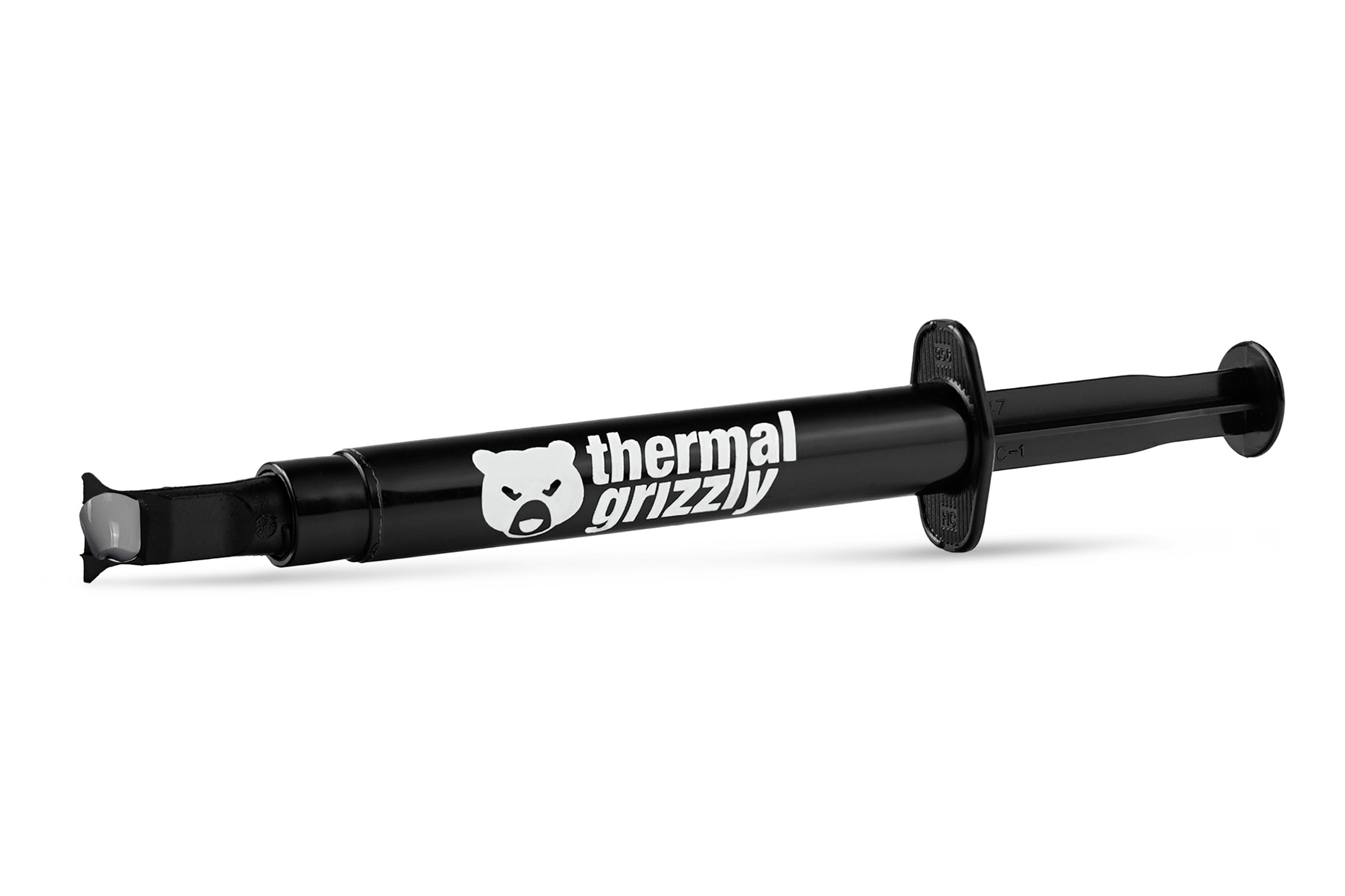 Jeringa negra con la marca thermal grizzly. La jeringa tiene una sustancia blanca en la punta.