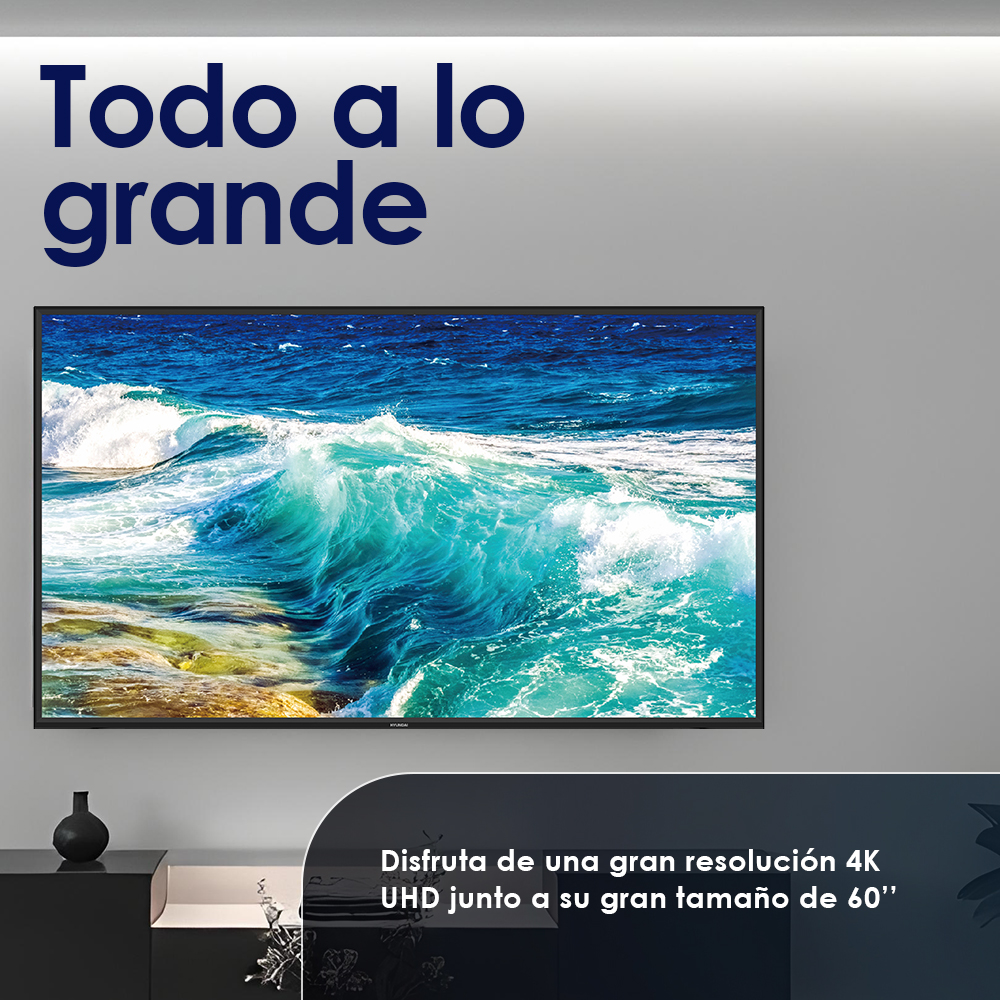 Una pantalla de TV muestra un océano turquesa con olas. El texto dice 'Todo a lo grande'.