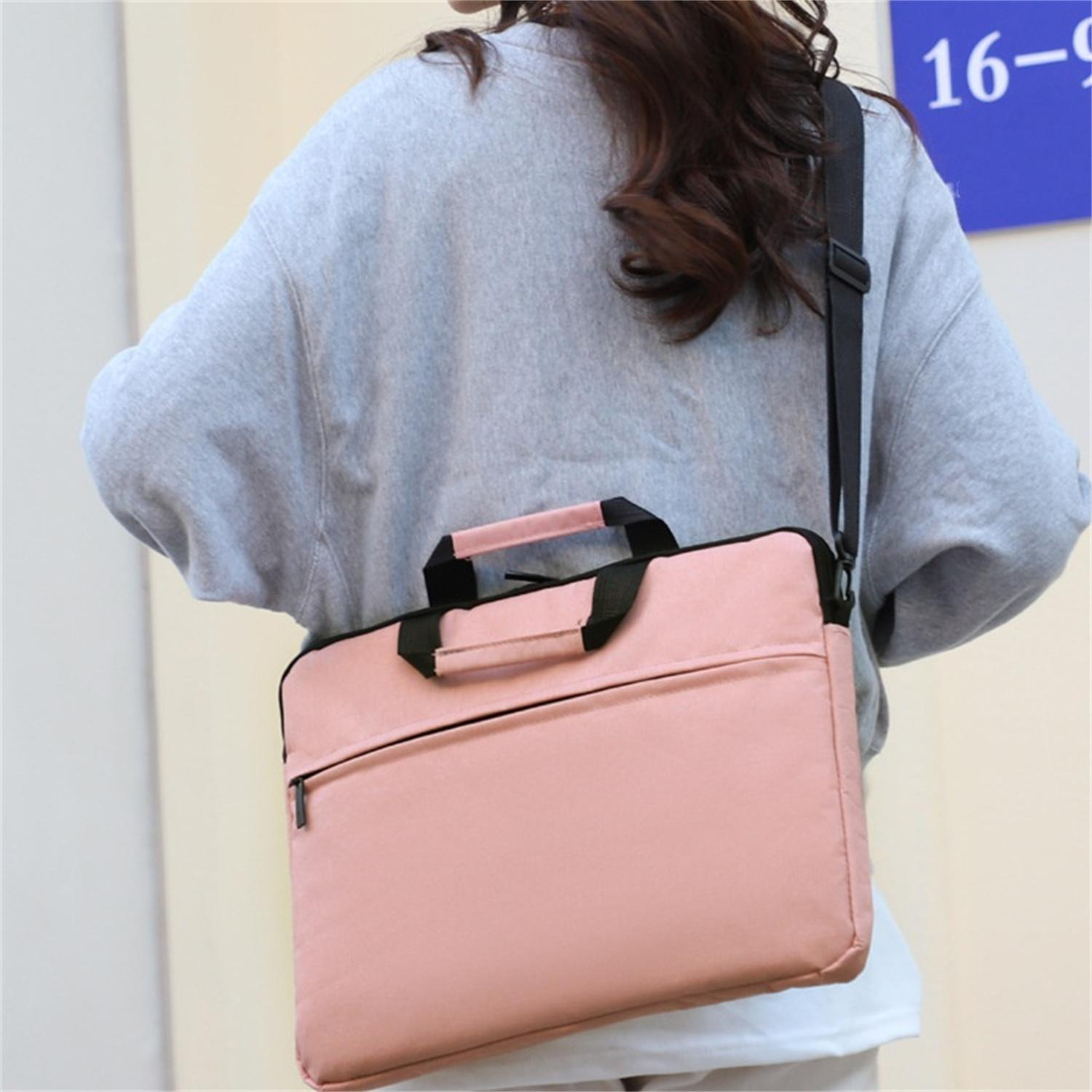 Eine Frau, die eine rosa Laptop-Tasche mit schwarzem Schultergurt trägt, geht mit verschwommenem Hintergrund.