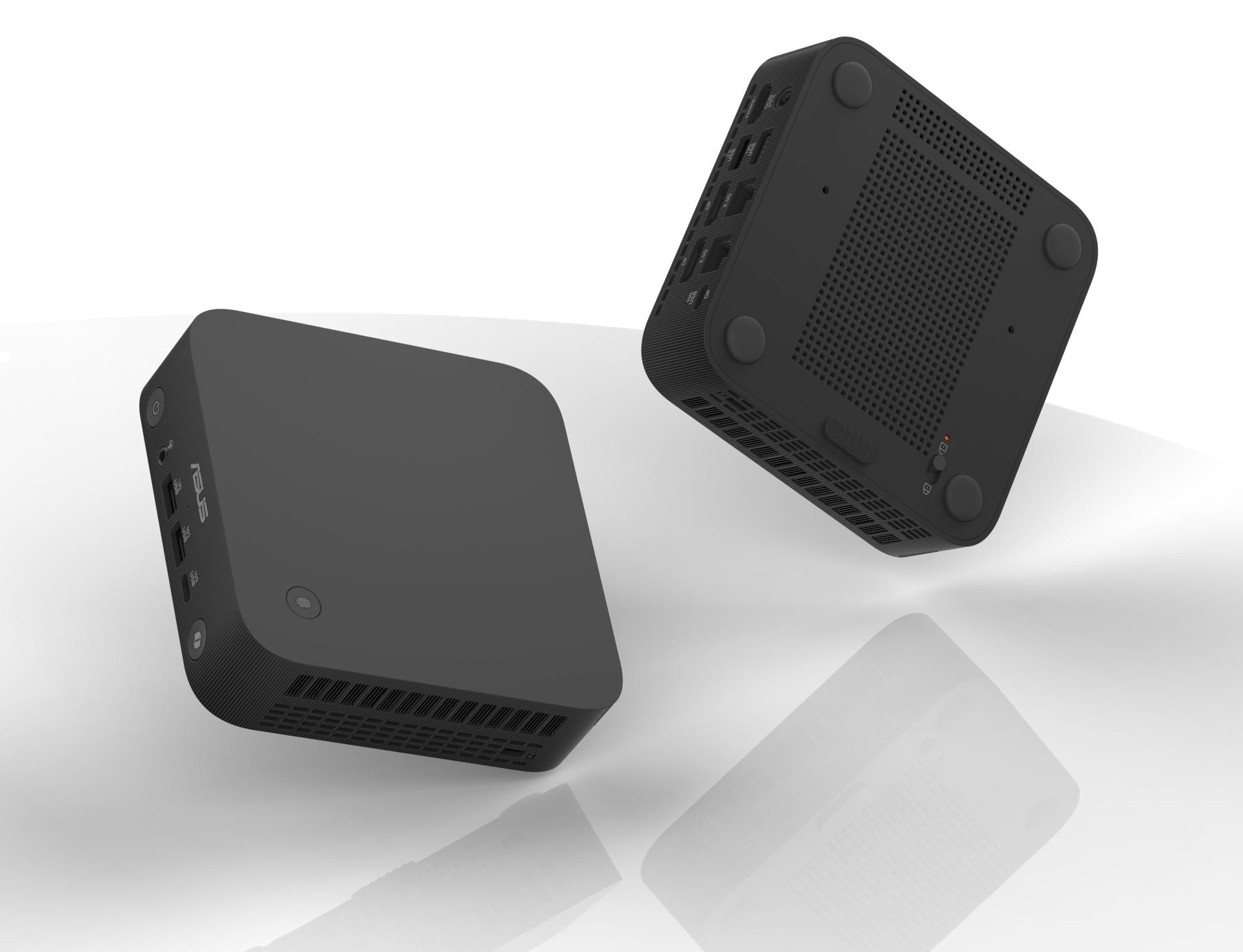 Dwa czarne mini komputery, jeden z portami, a drugi odwrócony, na białej powierzchni.