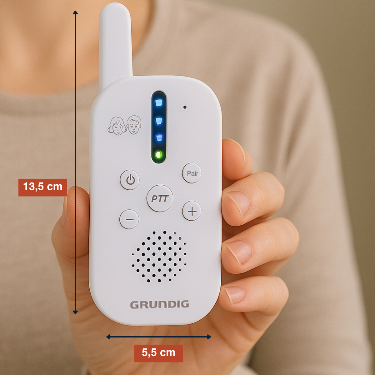 A person holding a white baby monitor, dimensions displayed: 13.5 cm and 5.5 cm.