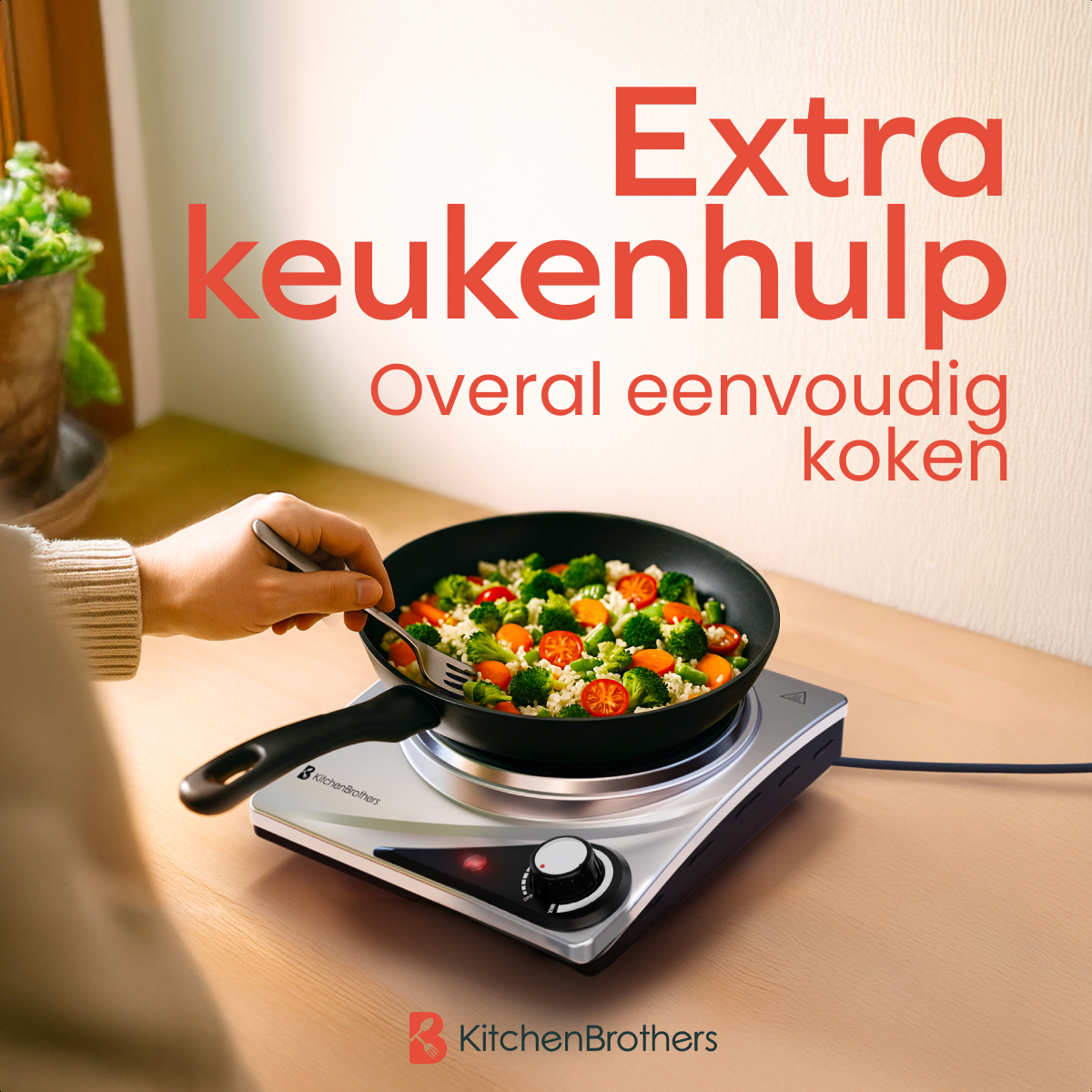 Person using a fork to stir-fry vegetables in a black pan on a silver KitchenBrothers electric stove.