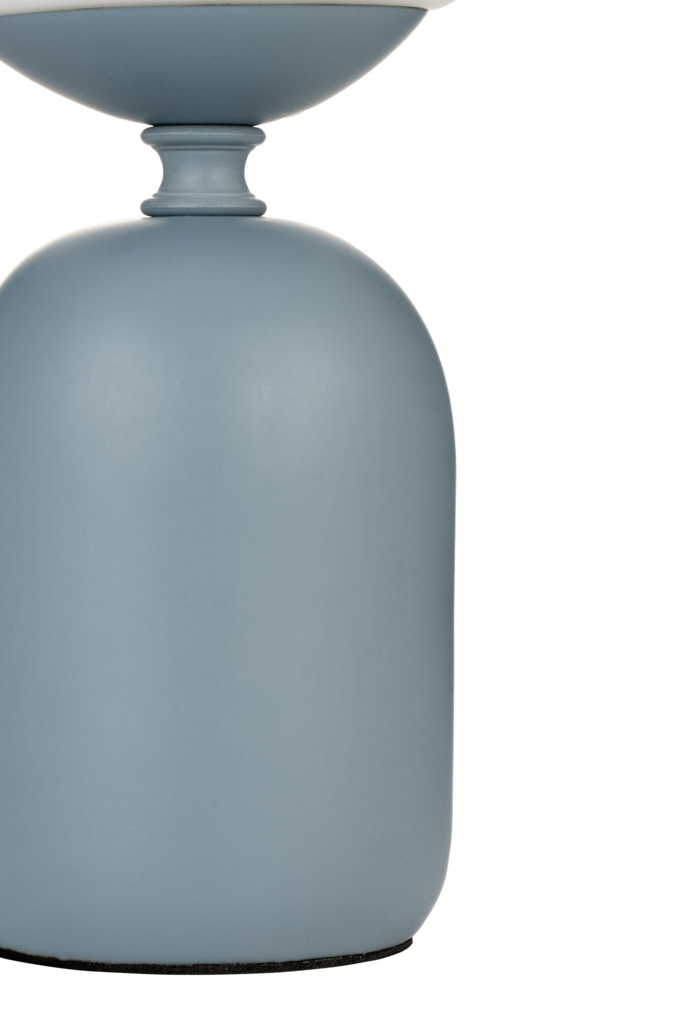 Wysoka, jasnoniebieska lampa z białym blatem. Podstawa jest zaokrąglona, z gładką powierzchnią. Białe tło.