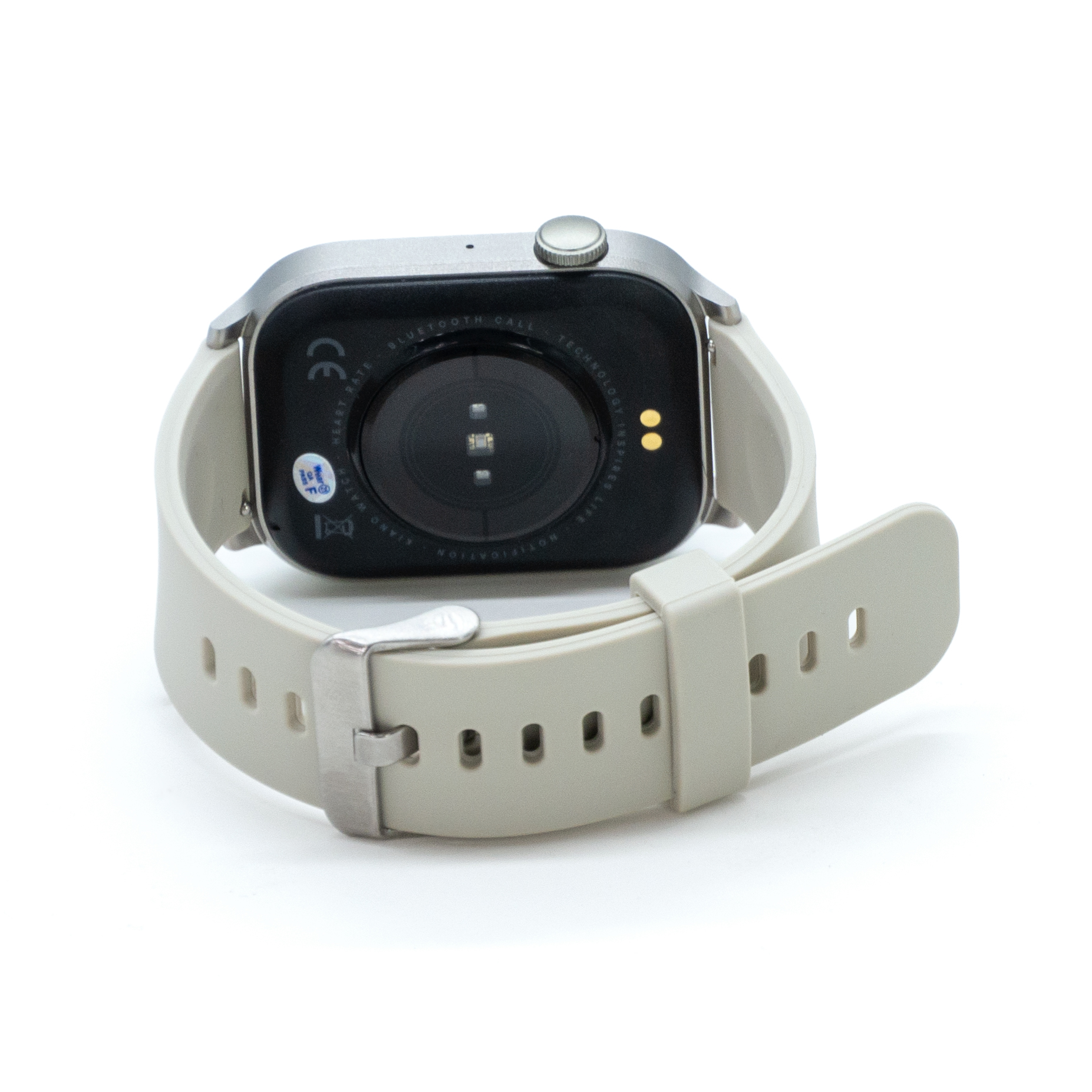 Parte trasera del smartwatch con sensores, un botón y correa gris claro. Fondo blanco. Detalles visibles.
