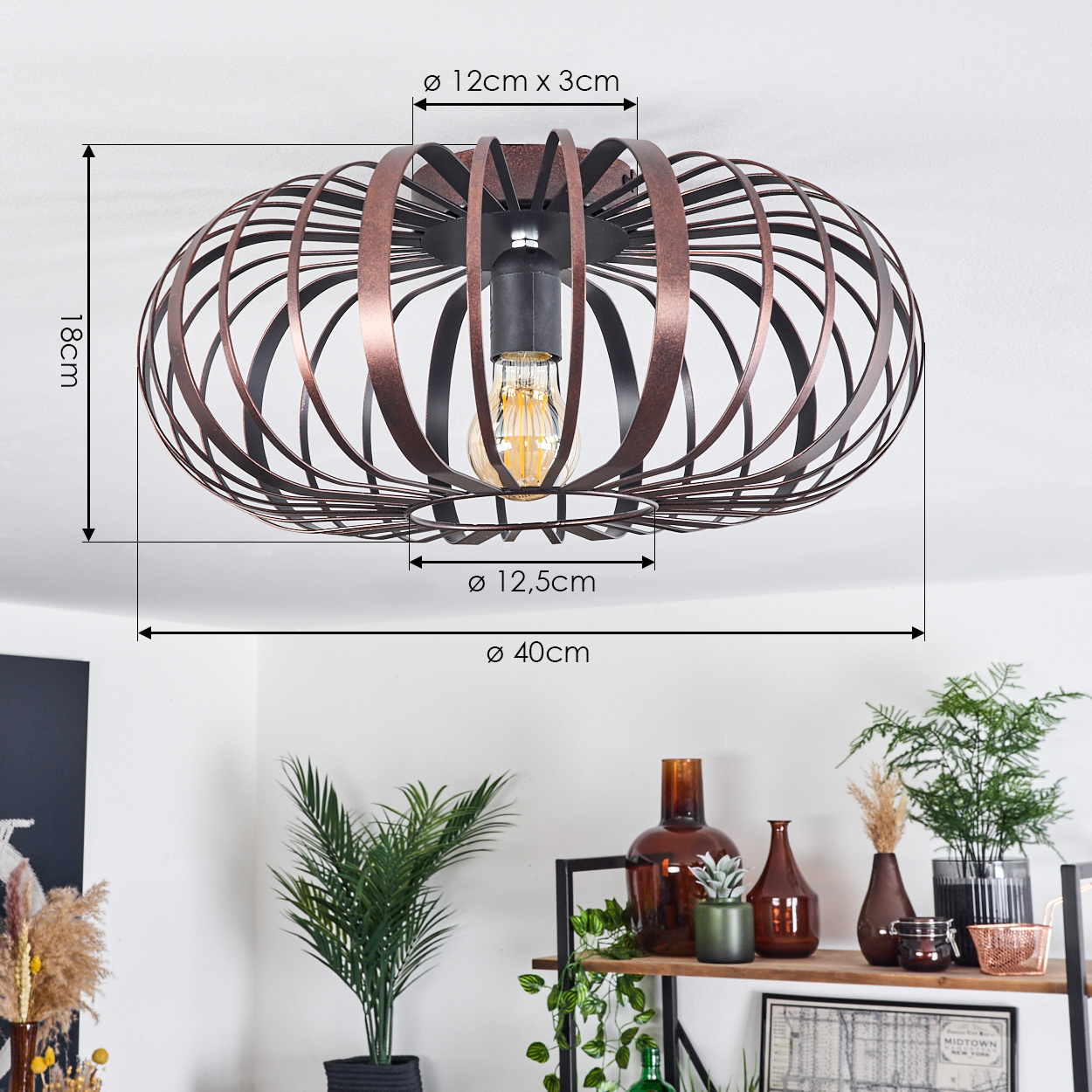 Deckenleuchte mit käfigartigem Design in Kupferfarbe. Maße der Leuchte sind beschriftet, Pflanzen im Hintergrund.