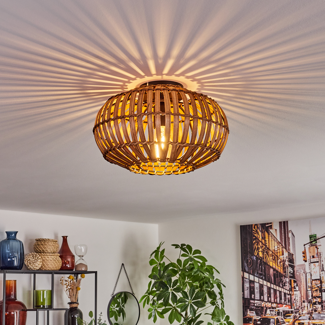 Eine Deckenleuchte aus Rattan mit strahlenden Lichtmustern vor einer weißen Decke.