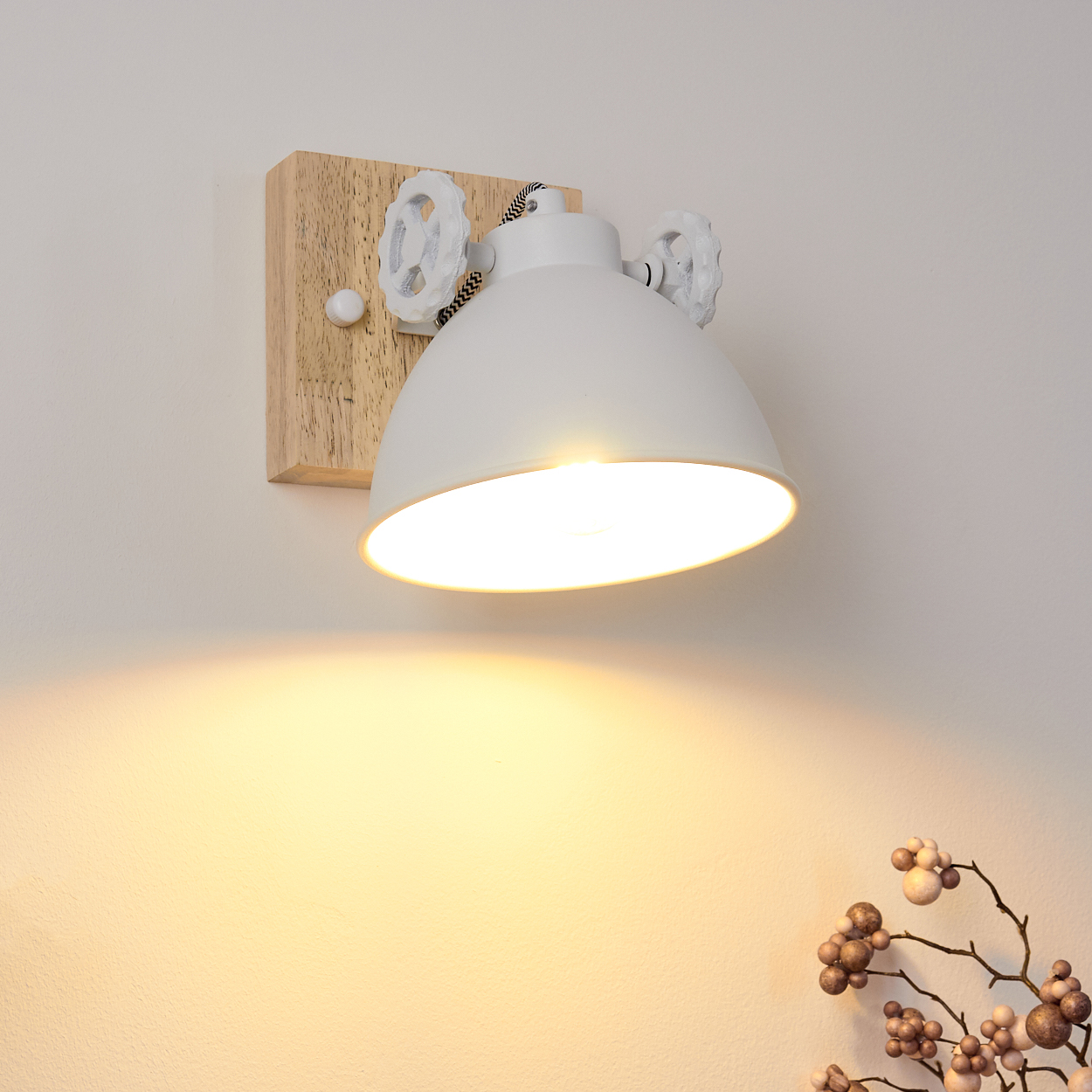 Weiße Wandleuchte mit Holzsockel. Die Lampe leuchtet nach unten.