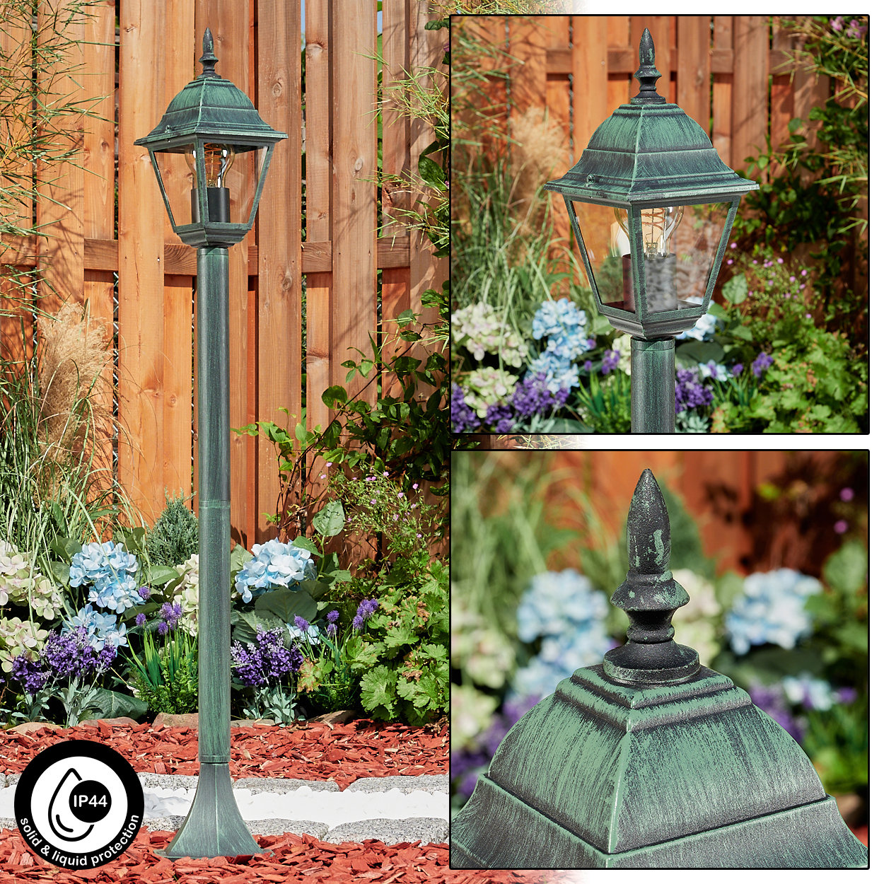 Eine Straßenlaterne im Freien mit grünem Finish. Sie steht in einem Garten mit Blumen und einem Holzzaun im Hintergrund.