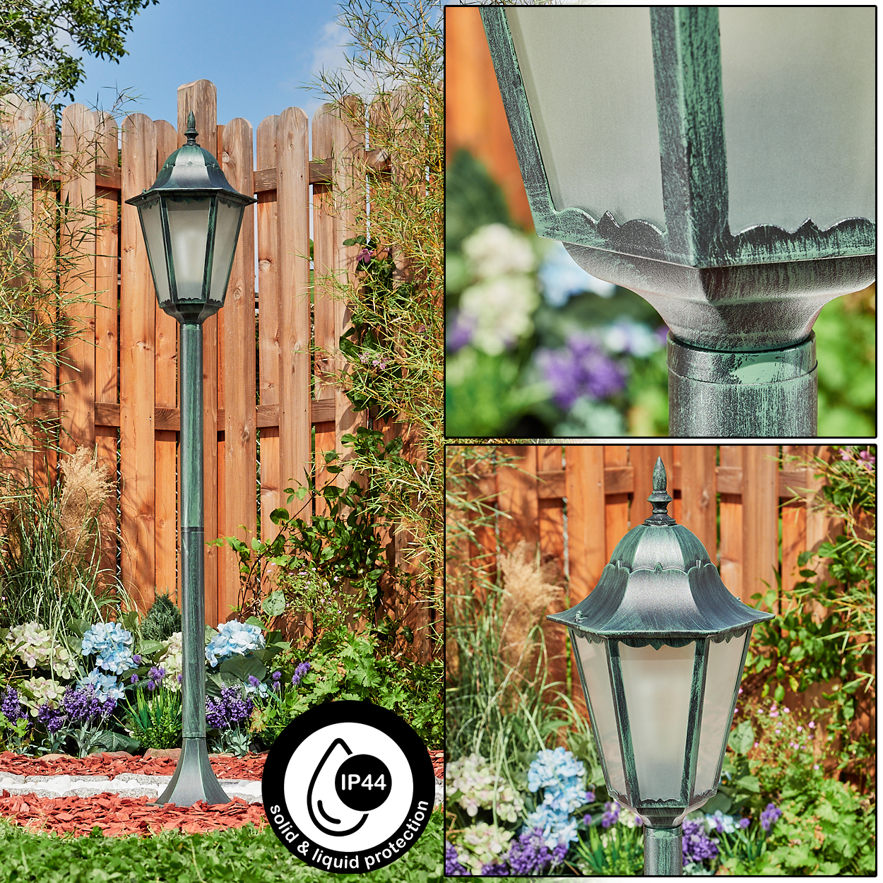 Eine hohe grüne Laterne mit einer Lampe aus Milchglas, in einem Garten mit Holzzaun und Pflanzen.