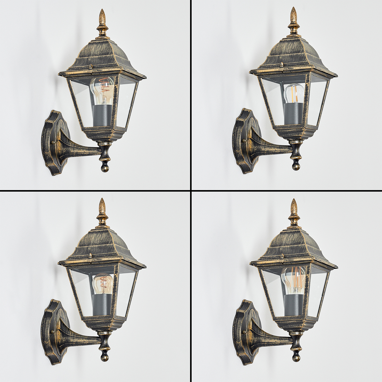 Vier identische Außenlampen an einer weißen Wand. Jede Lampe hat eine dekorative Spitze und klare Glasscheiben.