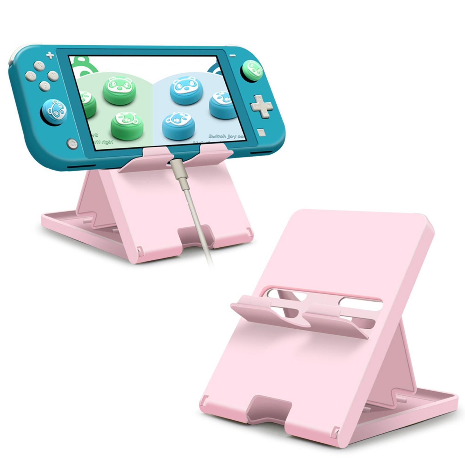 Rosa Ständer, der eine teal Nintendo Switch Lite mit Ladekabel hält. Es gibt auch einen separaten rosa Ständer.
