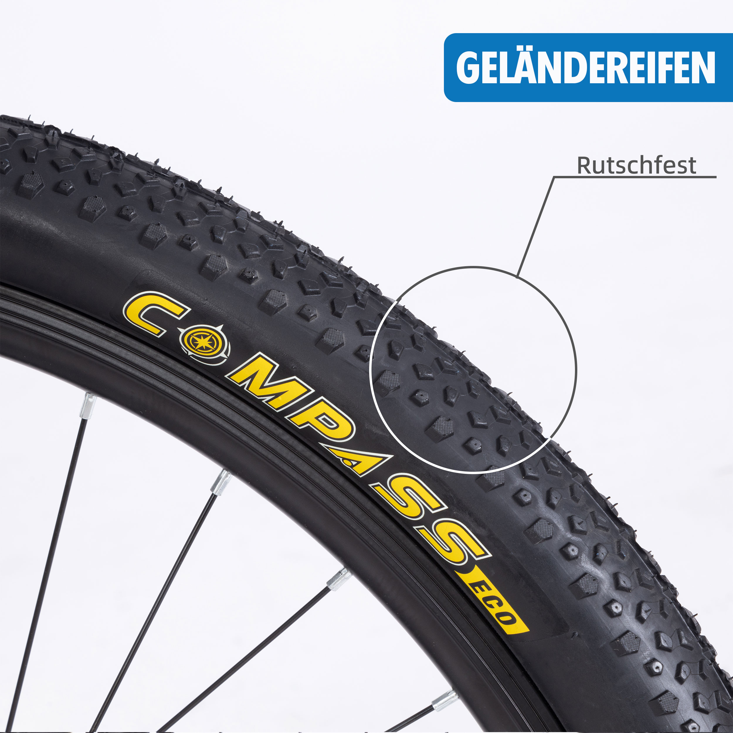 Nahaufnahme eines schwarzen Fahrradreifens mit gelbem Text 'COMPASS'. Der Reifen hat Profil und ist mit 'Rutschfest' markiert.
