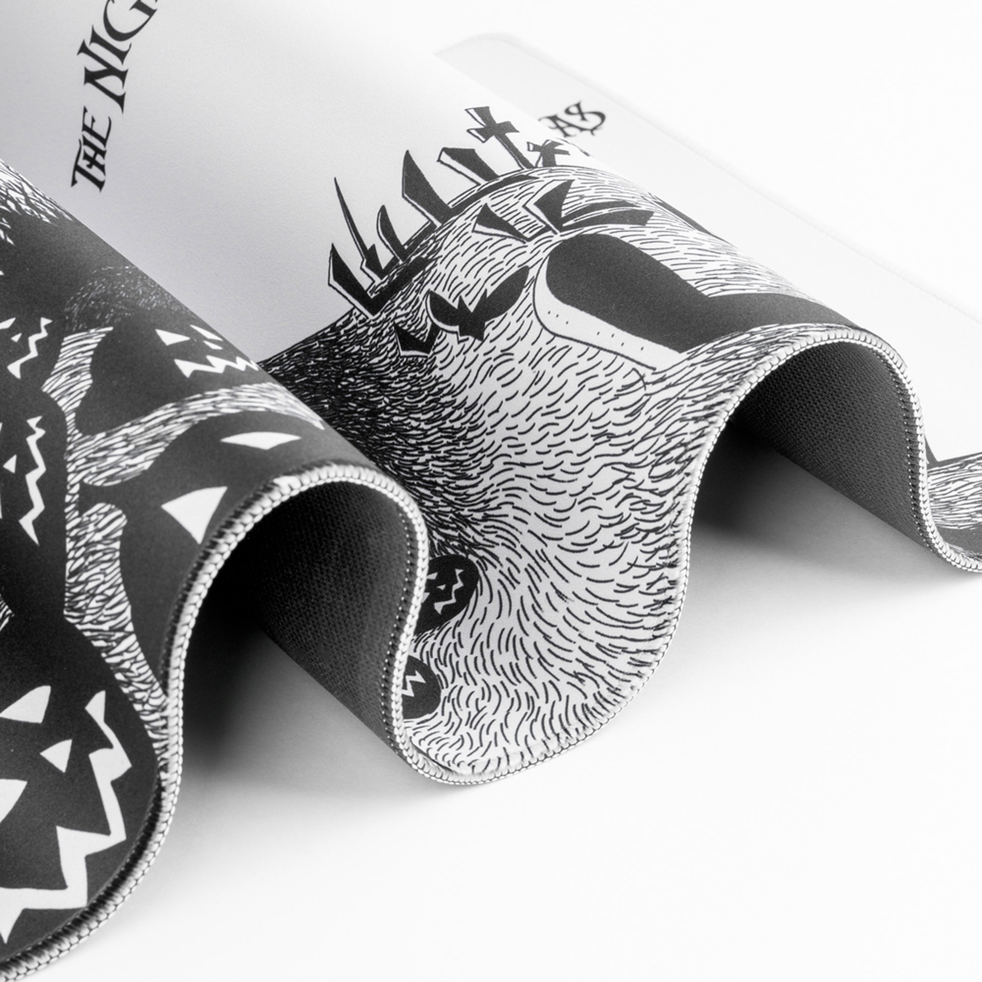 Gerolltes Mauspad mit einem schwarz-weißen Design mit The Nightmare Before Christmas-Figuren.
