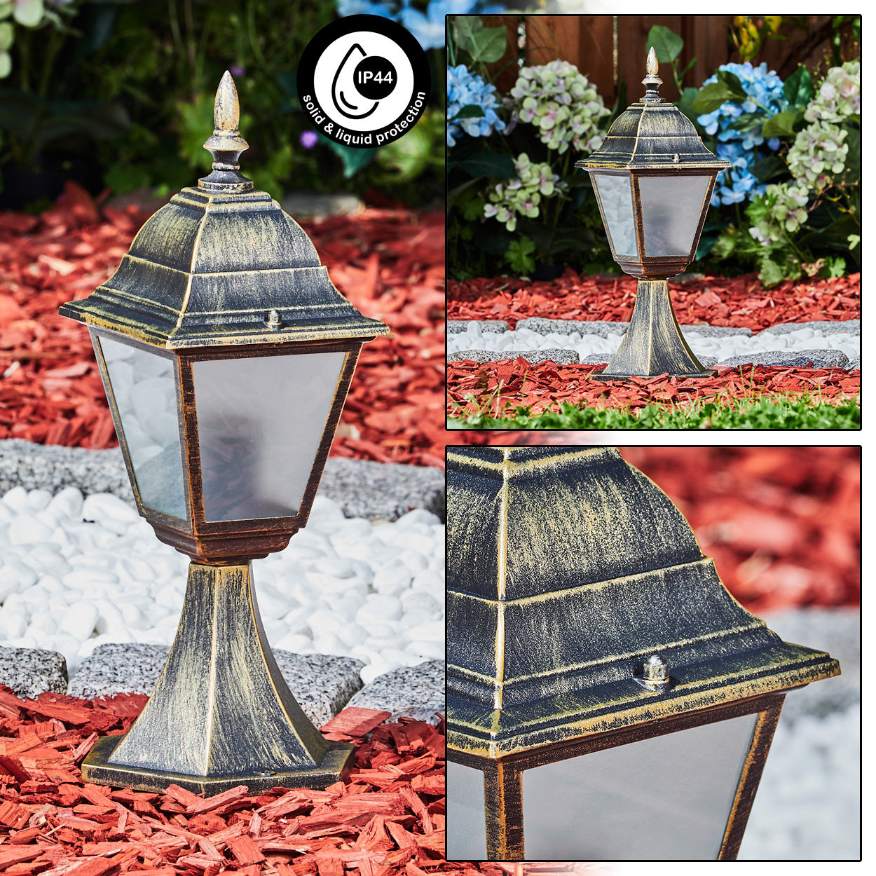 Eine bronzefarbene Außenlampe mit Glasscheibe auf roter Mulchbasis und weißen Steinen.