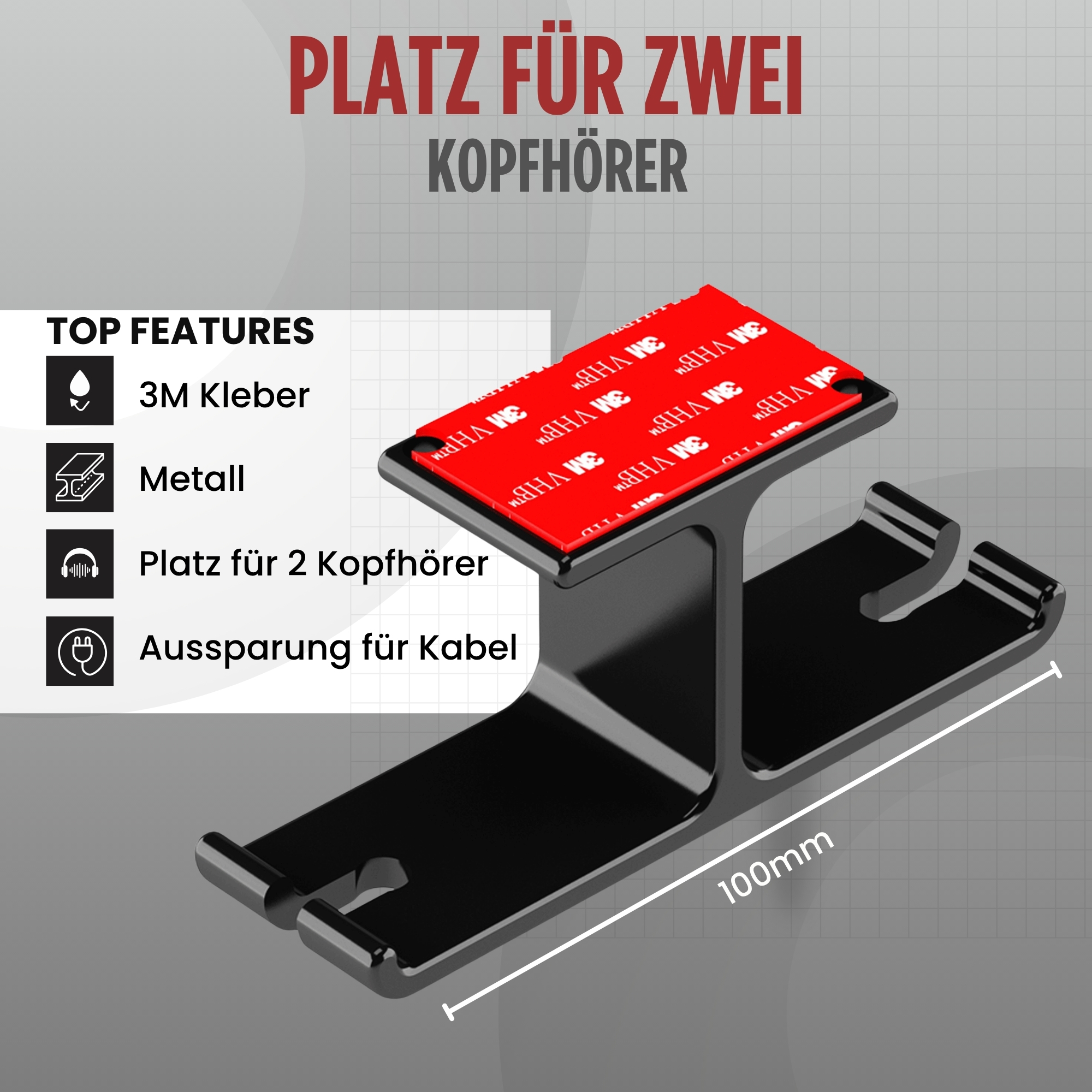 Ein schwarzer Kopfhörerhalter mit rotem Klebestreifen. Er kann zwei Kopfhörer halten und hat einen Kabelschlitz.