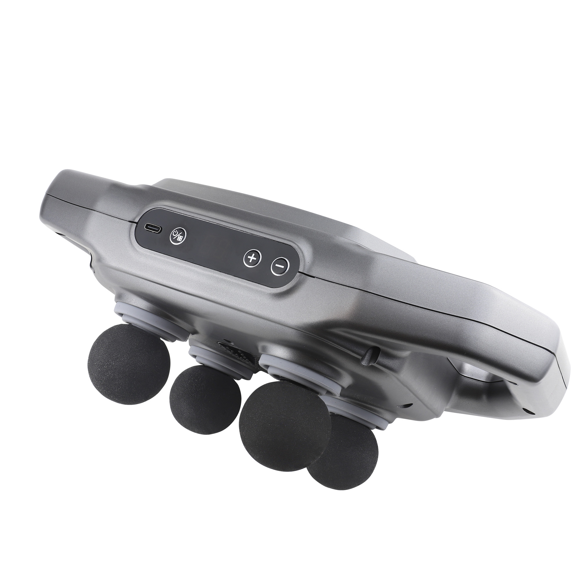 Srebrny pistolet do masażu z czterema czarnymi głowicami do masażu, skierowany w górę.