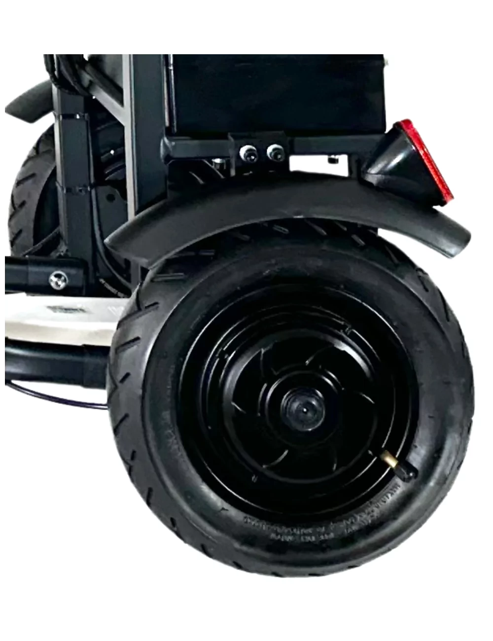 Primer plano de un neumático negro y una luz trasera roja en un scooter de movilidad.