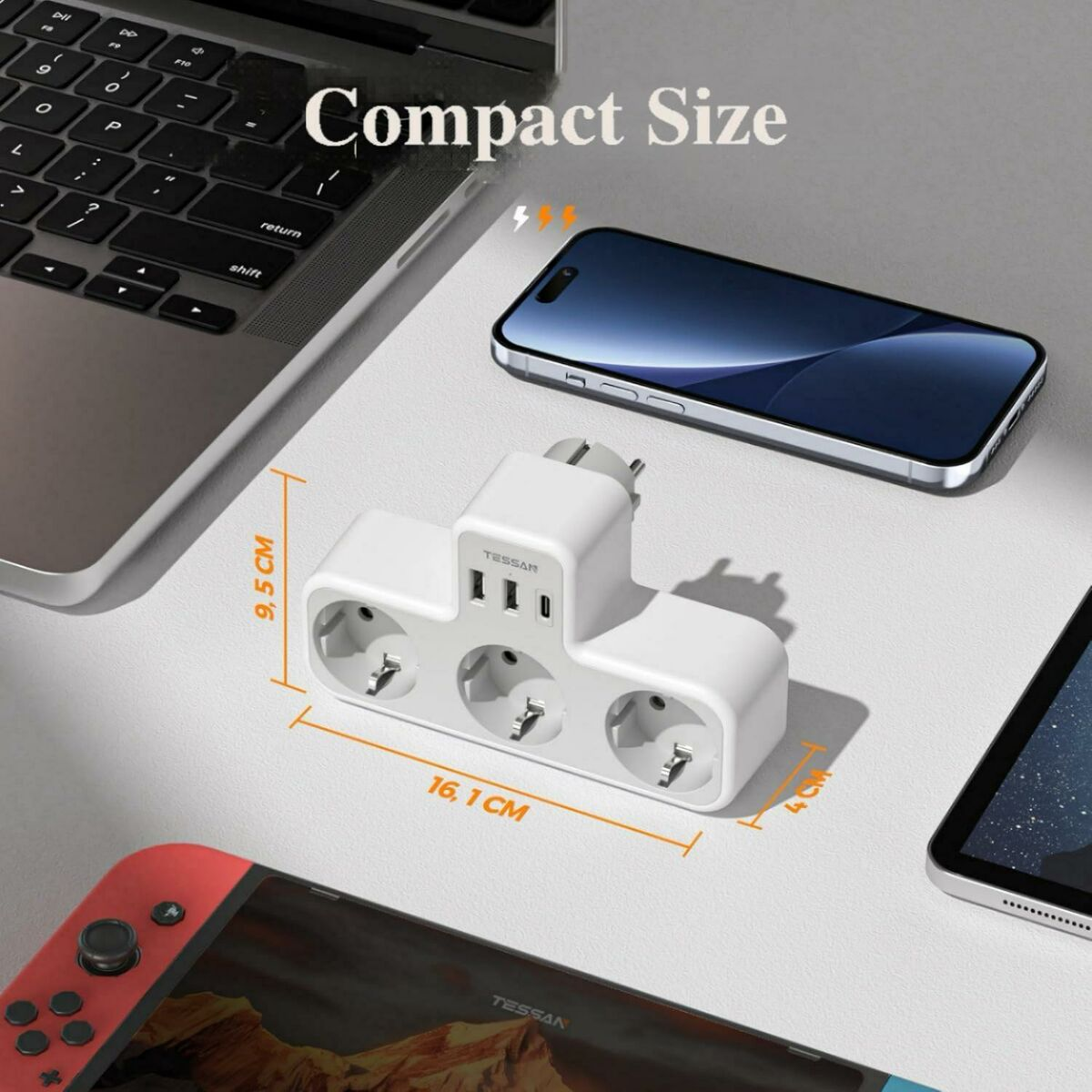 Un adattatore di alimentazione bianco con porte USB e prese, con laptop, telefono e switch.