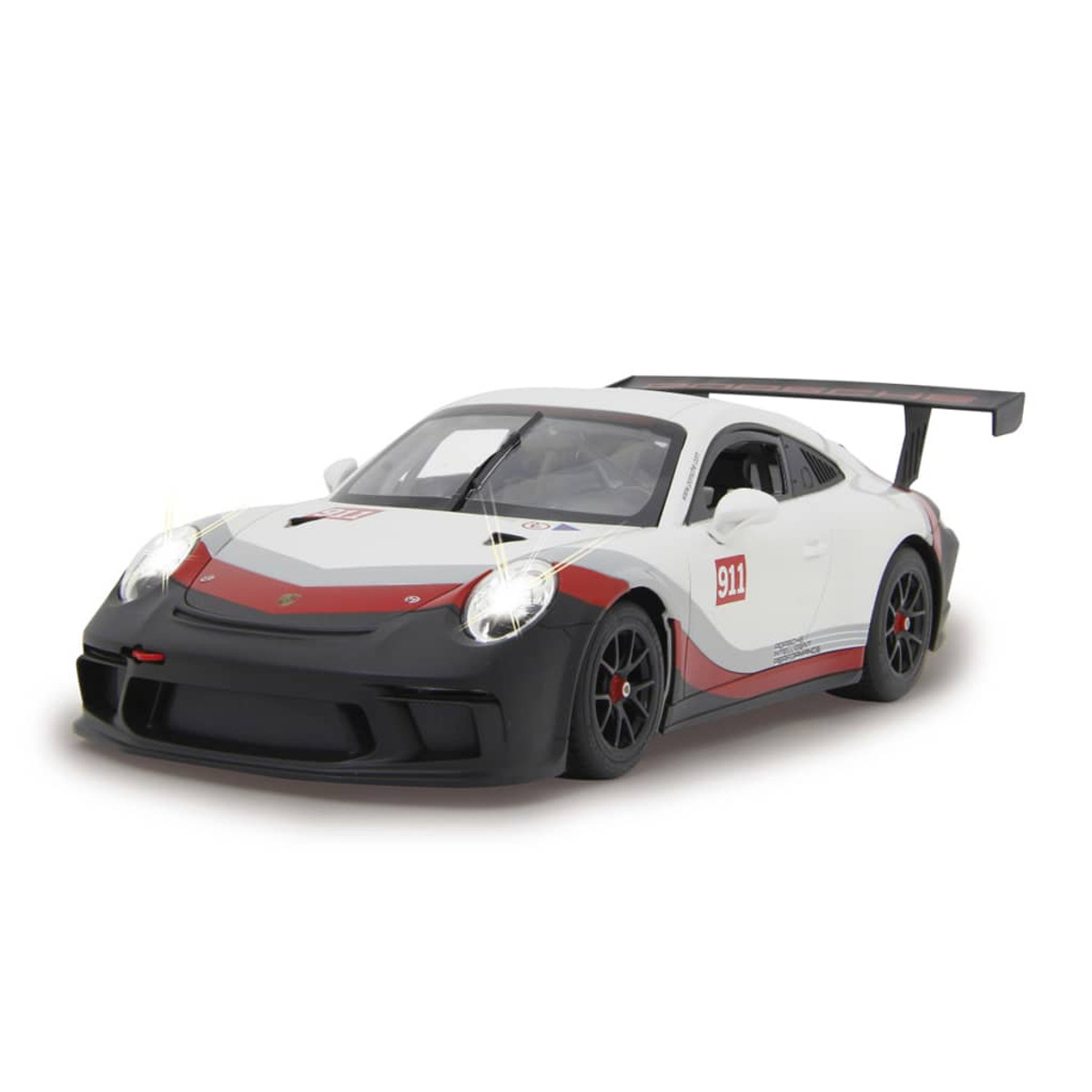 Ein weißes und rotes Porsche 911 Spielzeugauto. Scheinwerfer sind an. Schwarze und rote Details.
