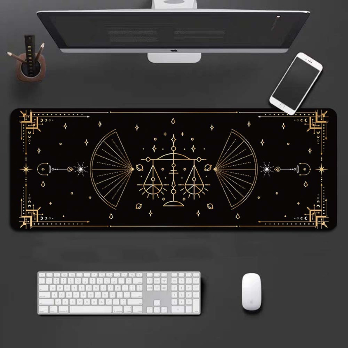 Black and gold decorated desk mat with keyboard, mouse, computer, and phone.