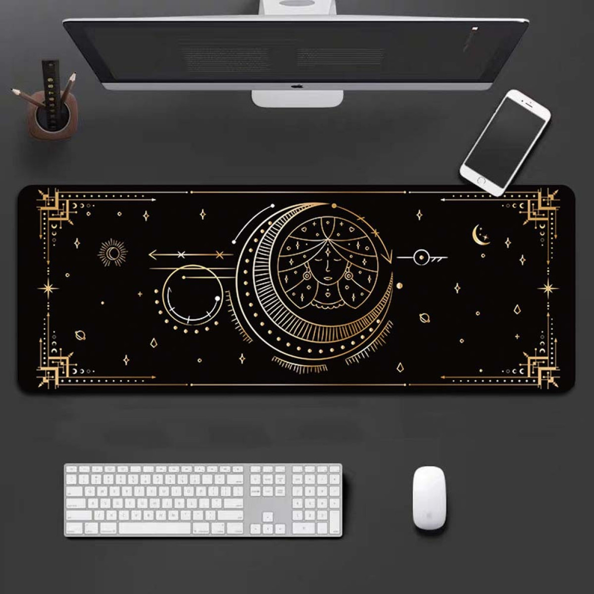Black desk mat with golden celestial design, keyboard, mouse, phone, and monitor.