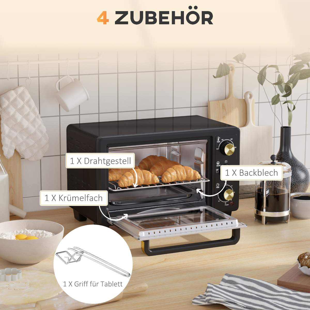 Ein schwarzer Mini-Backofen mit Croissants im Inneren. Etiketten weisen auf Rost, Krümelschale und Zubehör hin.