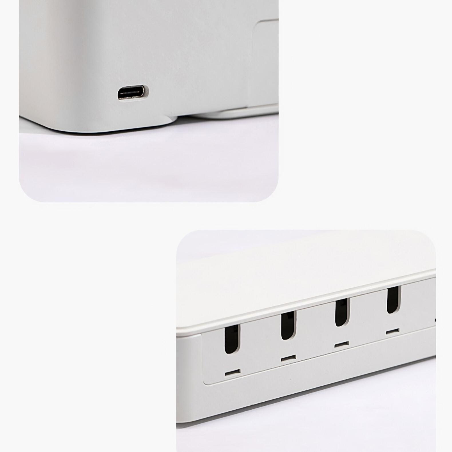 Nahaufnahmen einer weißen Box mit USB-Anschluss und einer Reihe rechteckiger Schlitze.