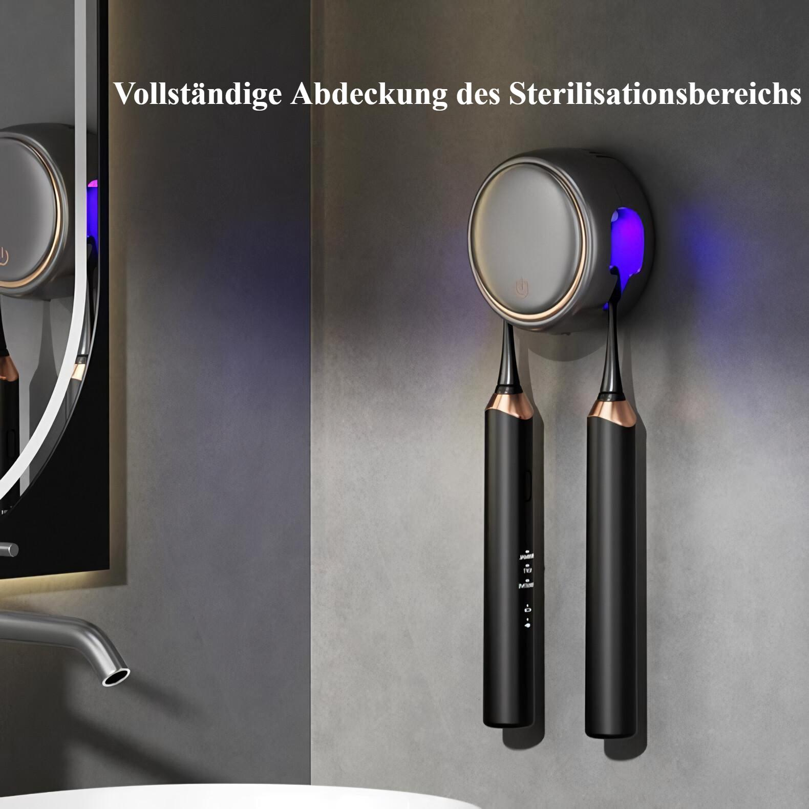 Ein schwarz-goldener Zahnbürstensterilisator mit Zahnbürsten und einem Spiegel im Hintergrund.