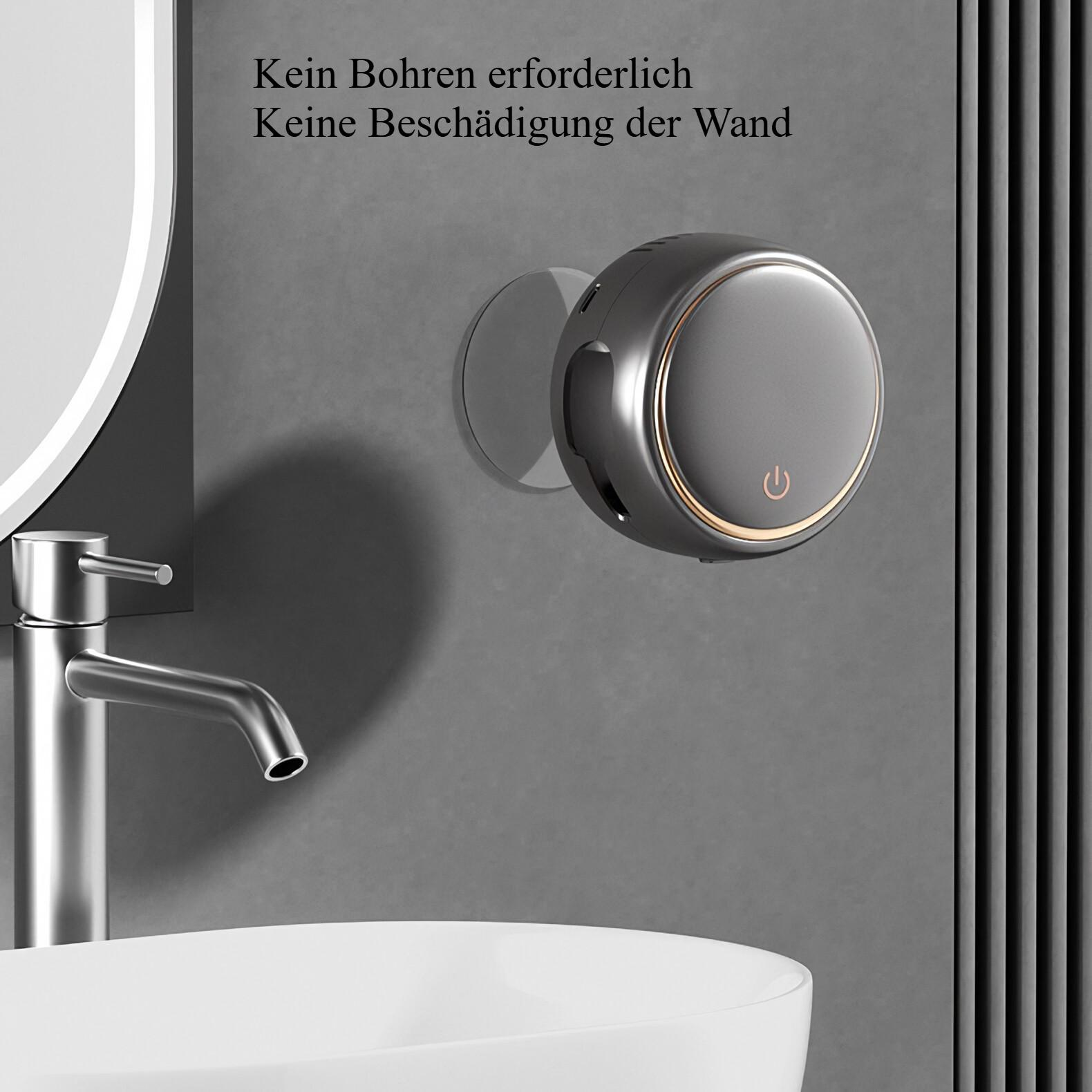 Ein silbernes Gerät, das ohne Bohren an einer Wand montiert ist, neben einem Waschbecken und einem Spiegel.