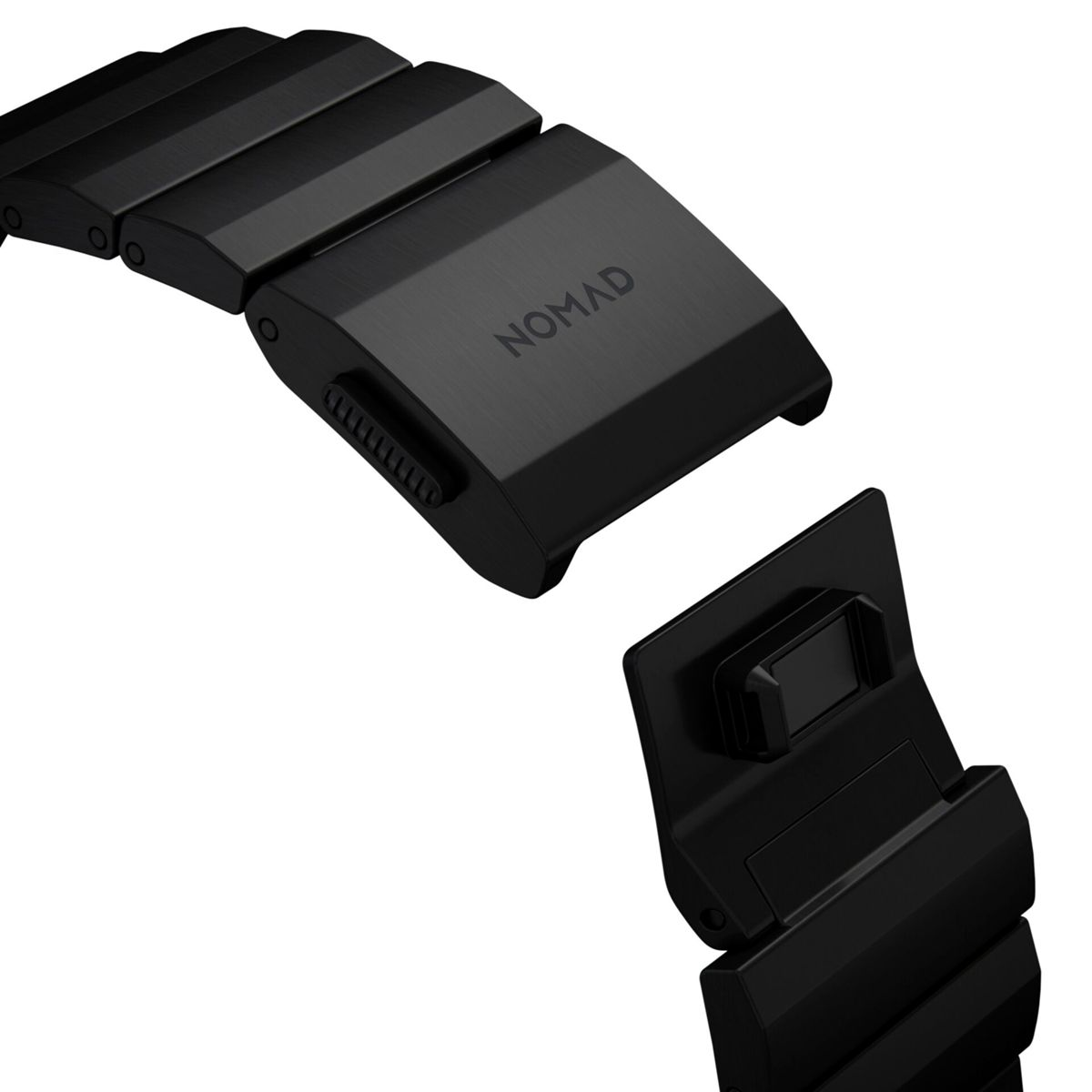 Nahaufnahme eines schwarzen Uhrenarmbandverschlusses. Der Verschluss ist aus Metall, das Wort NOMAD ist sichtbar.