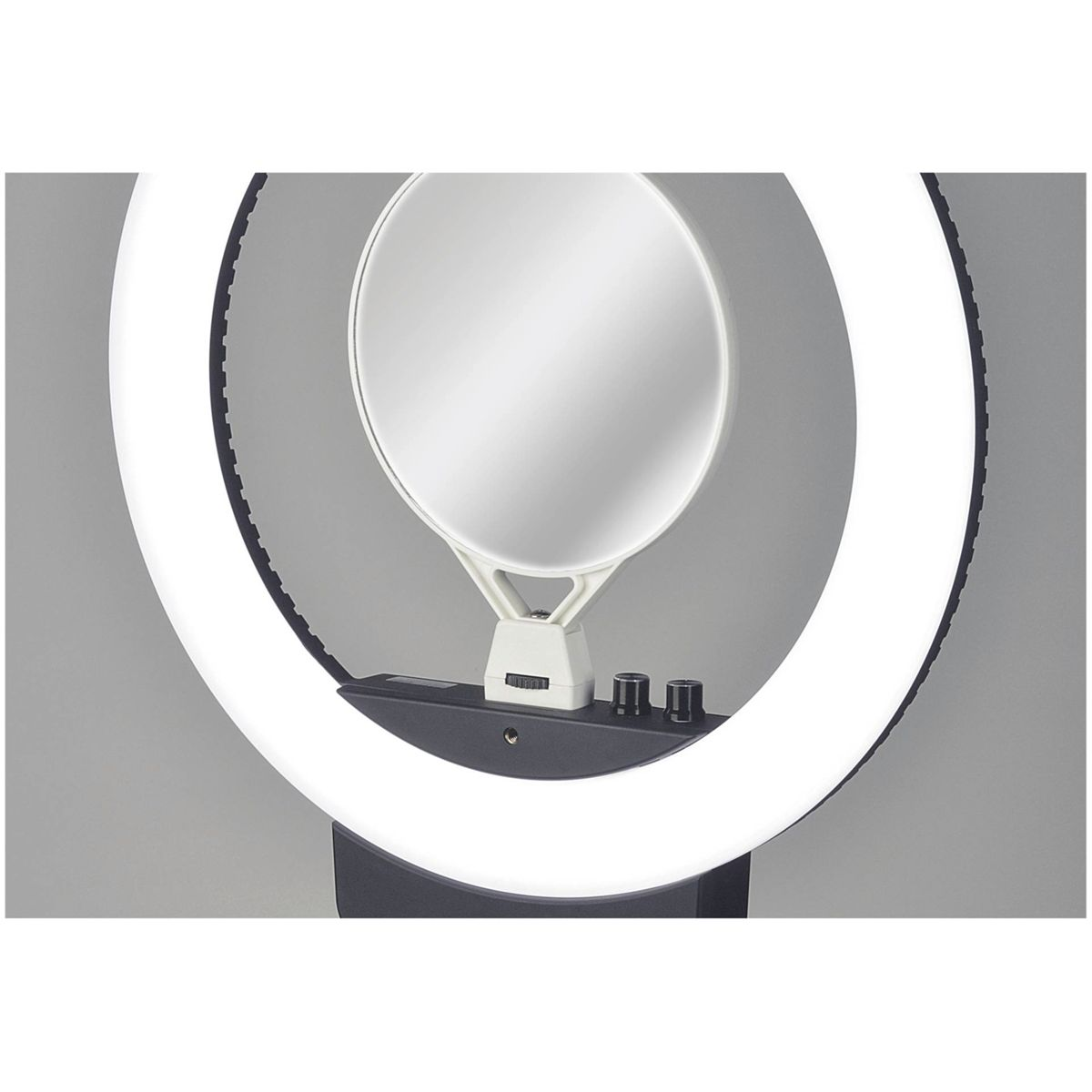 Una luce ad anello con una matrice LED circolare, uno specchio centrale e comandi su una base scura.
