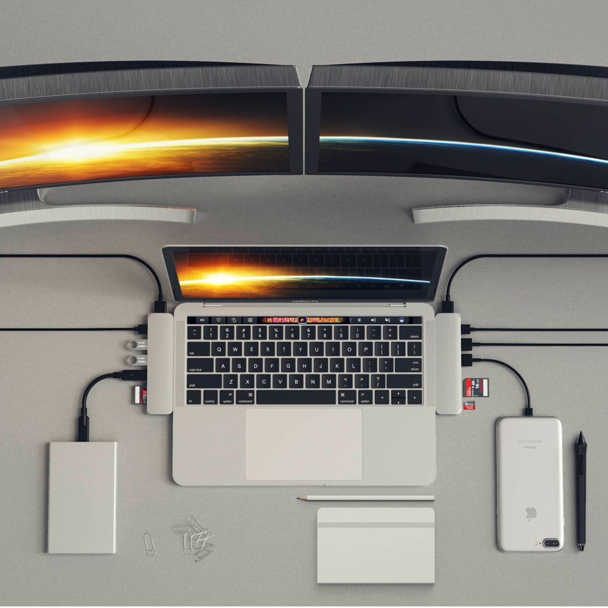 A top-down view of a laptop connected to various devices, including monitors and a phone.