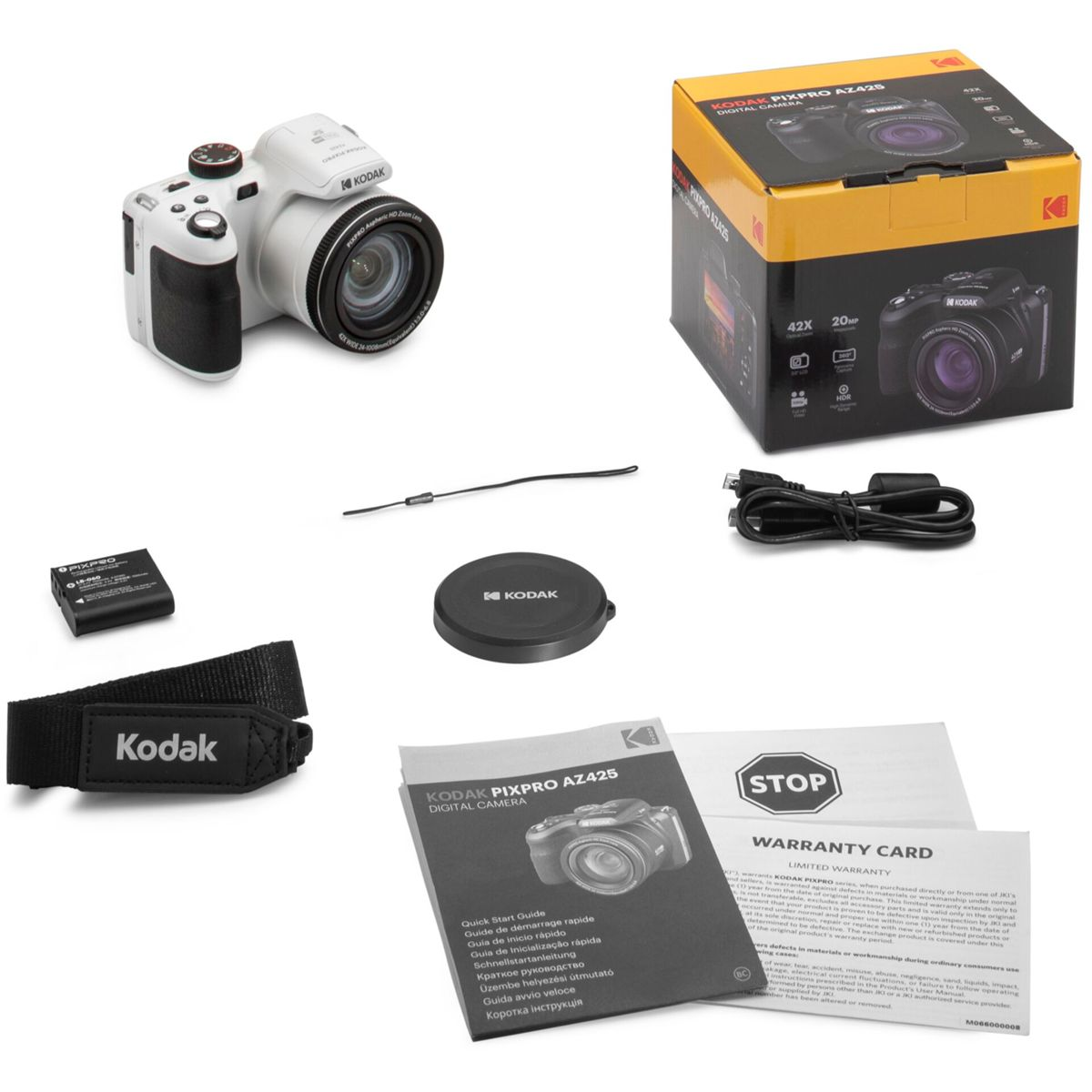 Biały aparat z akcesoriami i opakowaniem, w tym baterią, paskiem i instrukcjami.