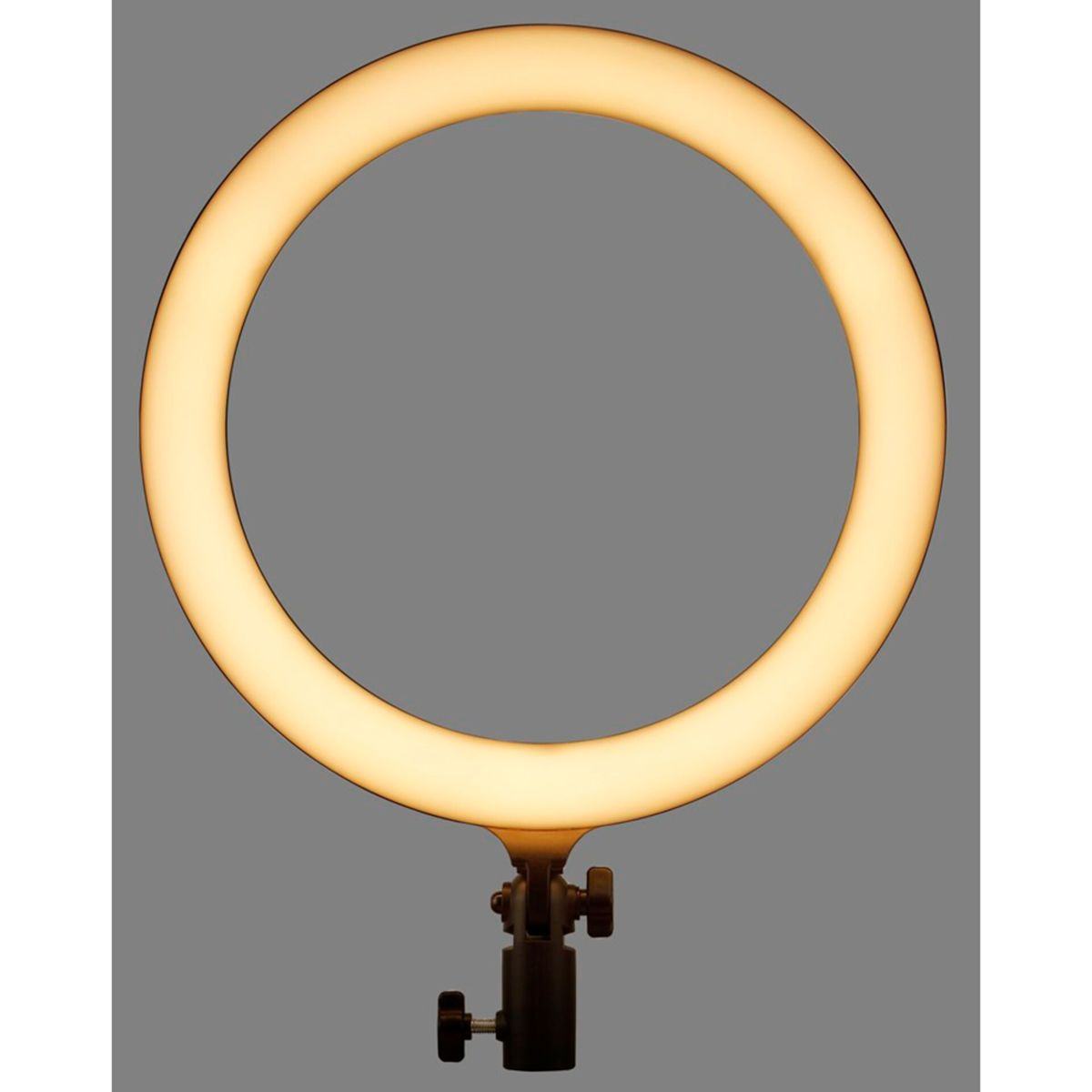 Ein Ringlicht auf einem Ständer, das warmes, gelbes Licht aussendet. Der Hintergrund ist grau.