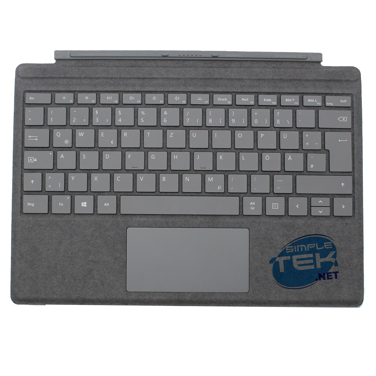 Graue Tastaturabdeckung mit Tasten und Touchpad. Sie hat einen Aufkleber mit simple tek net.