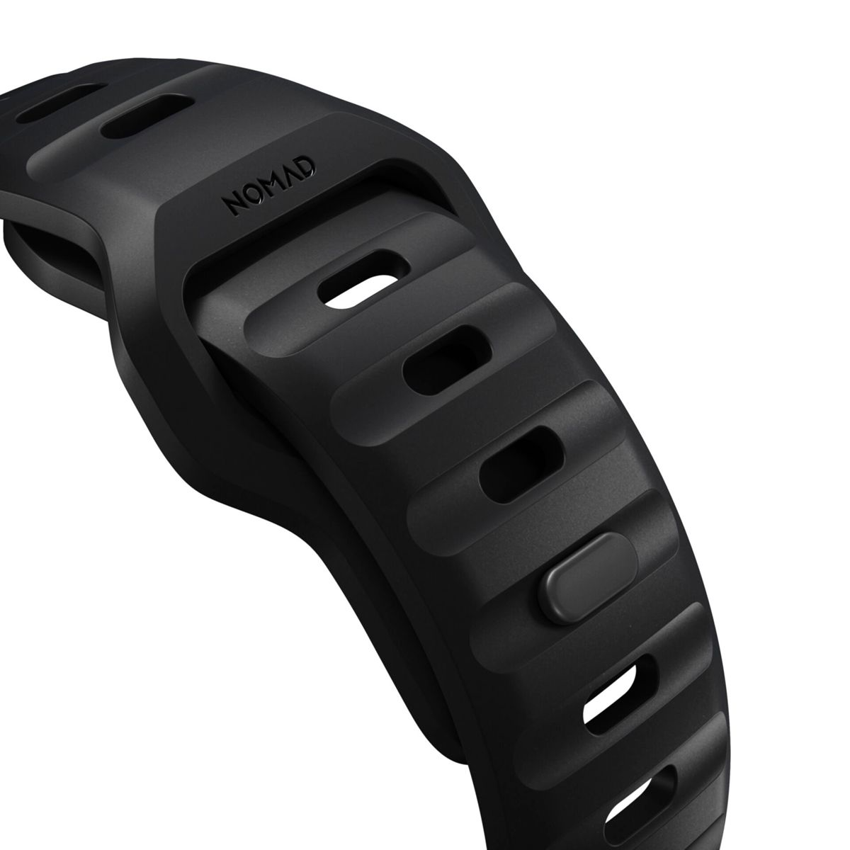 Schwarzes Uhrenarmband mit dem Wort 'NOMAD'. Das Band hat eine strukturierte Oberfläche mit Schlitzen.