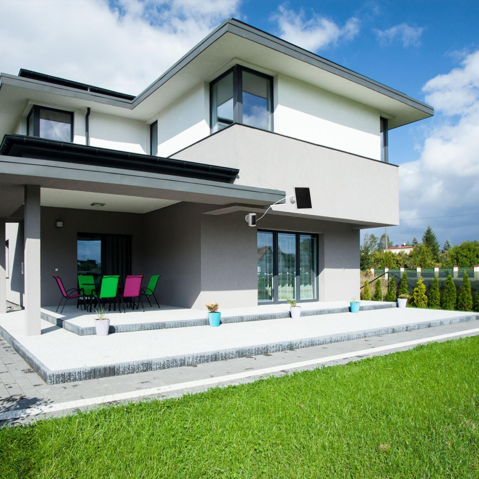 Ein Haus mit modernem Design, ein Solarpanel und ein grüner Rasen. Eine Person geht auf dem Rasen.