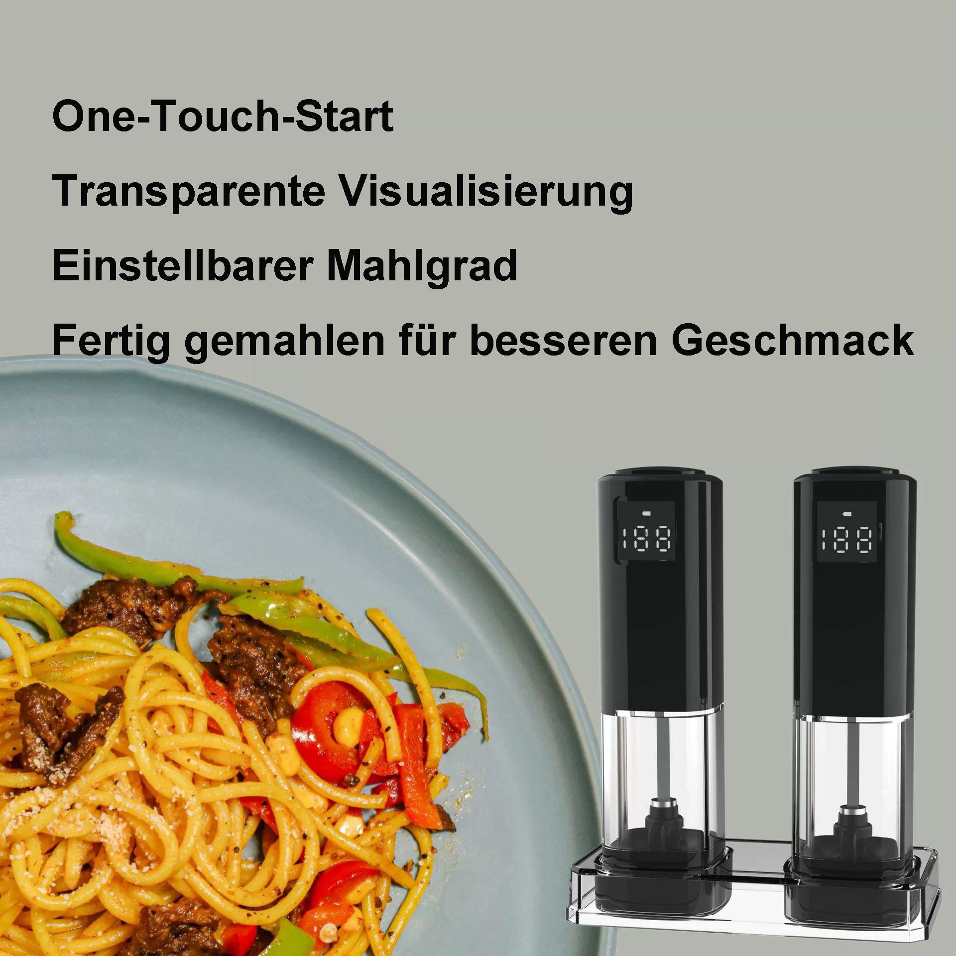 Ein Teller Nudeln mit Gemüse neben zwei schwarzen elektrischen Pfeffermühlen auf einem Metallständer.