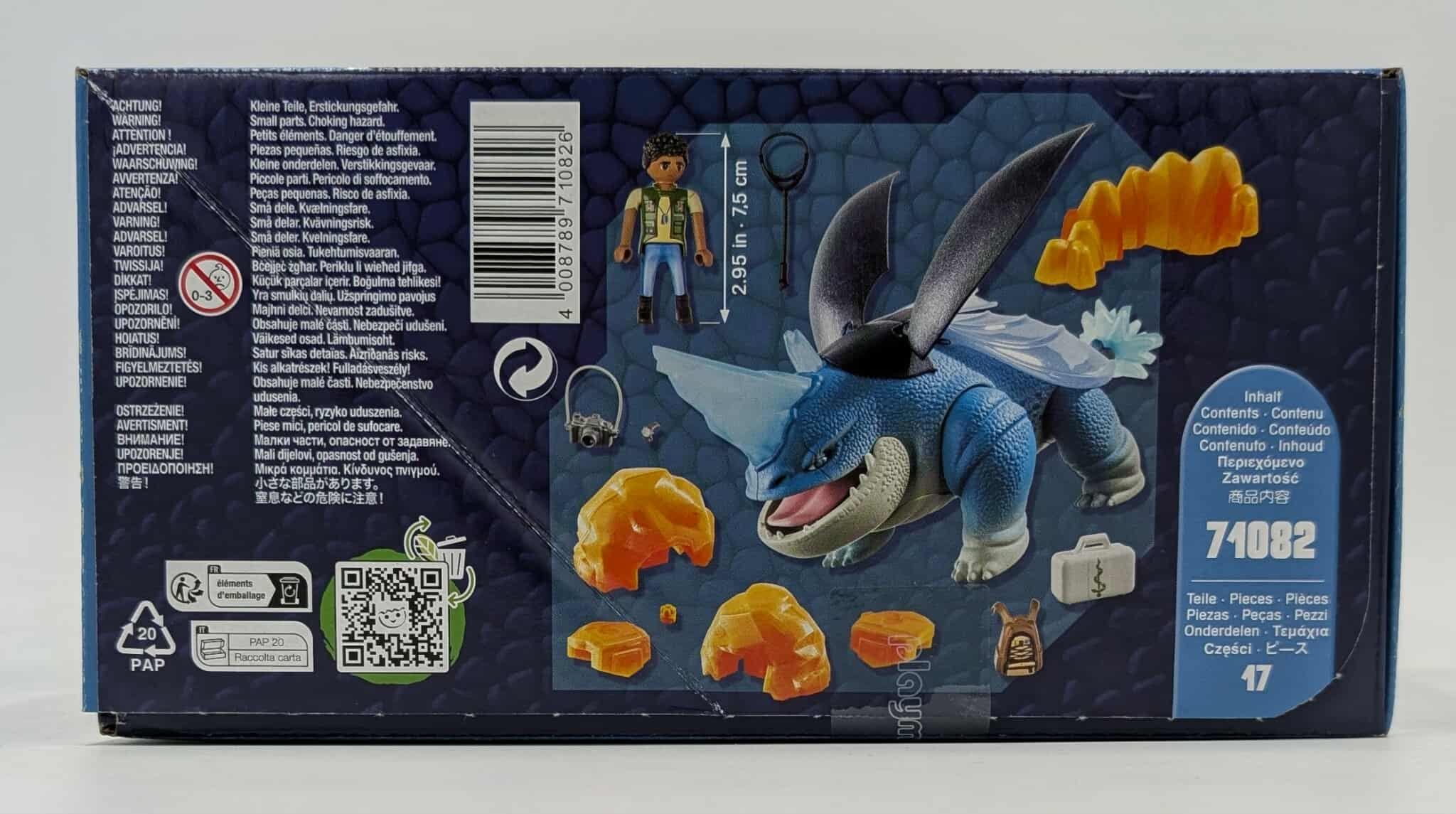Schachtel mit Playmobil-Set, Figur reitet blauen Drachen, Zubehör und Textetiketten.