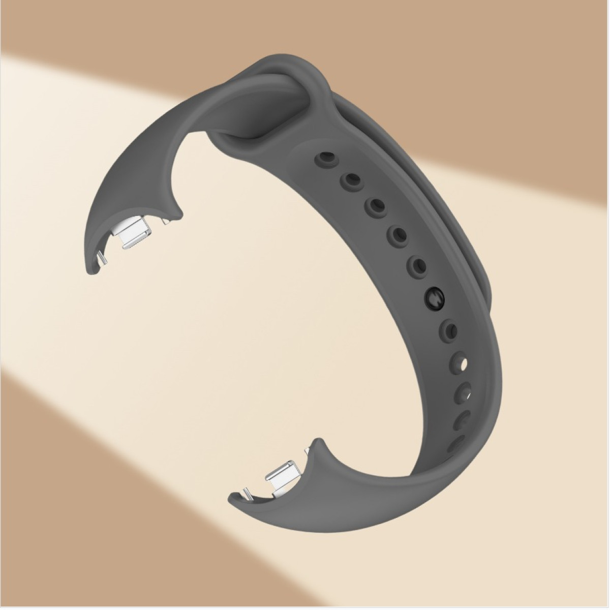 Ein graues Armband mit Verstelllöchern und Metallverschlüssen liegt auf einer beigen Oberfläche mit einer Blume daneben.