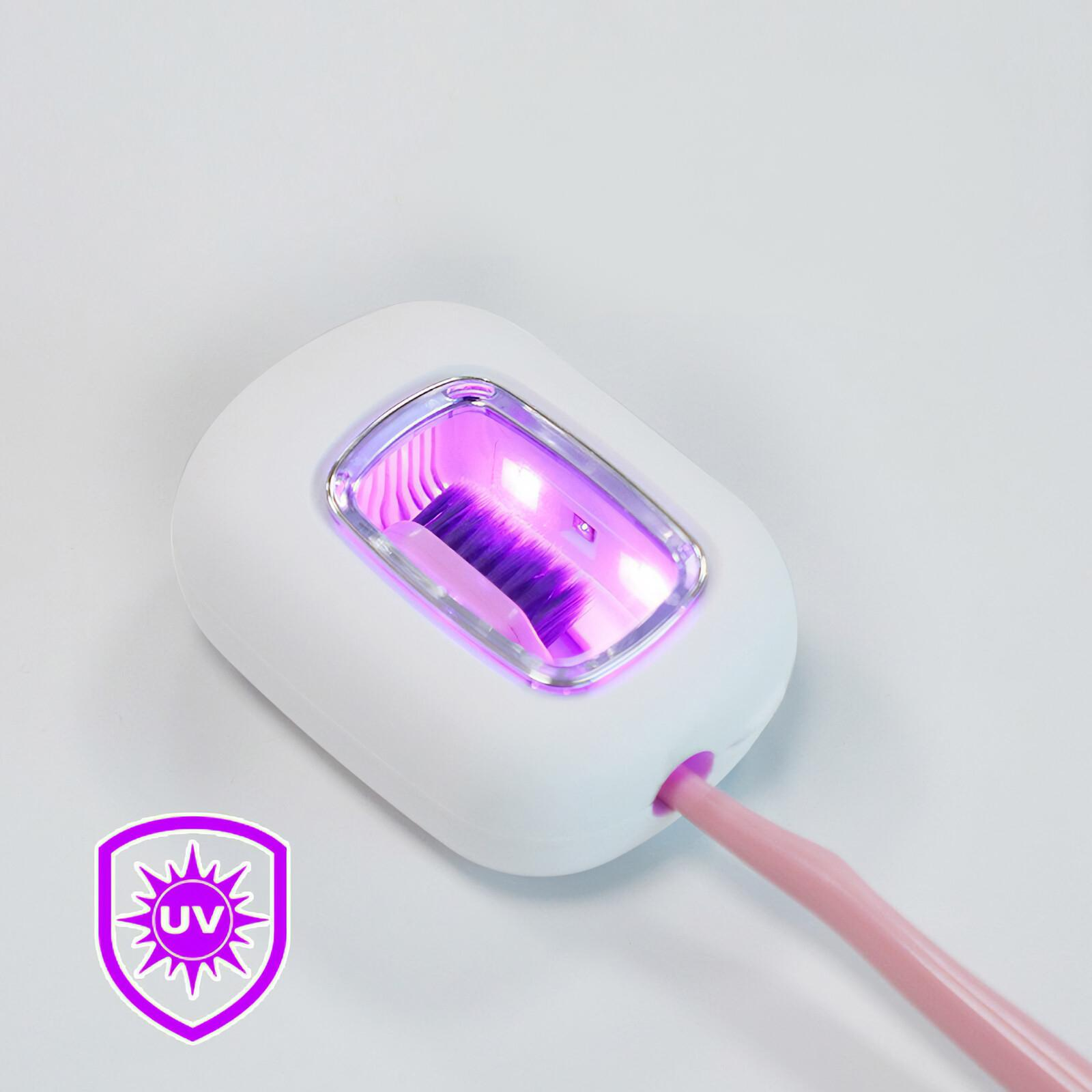 Ein Zahnbürsten-Desinfektionsgerät mit rosa Griff, das violettes Licht aussendet.