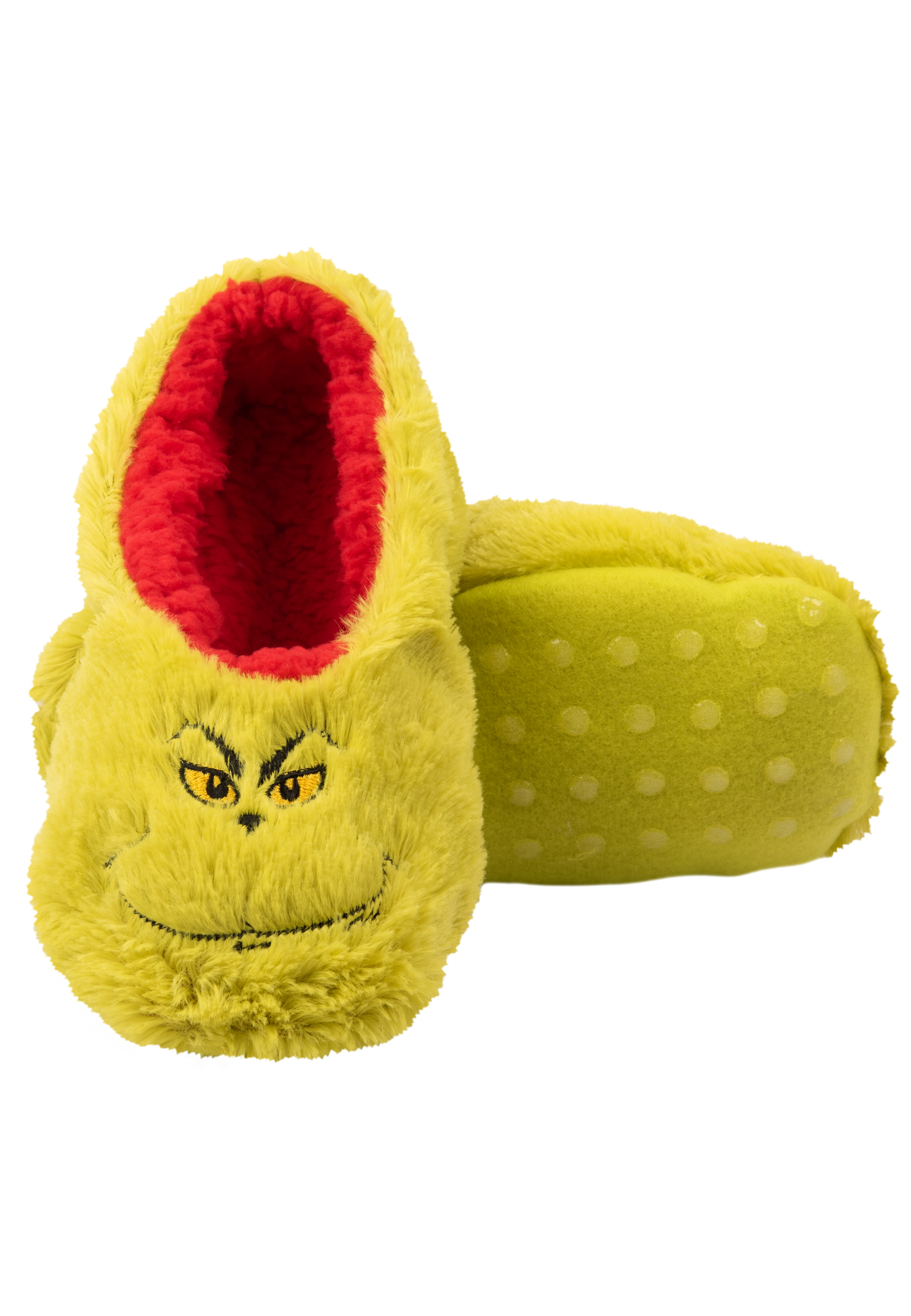 Ein Grinch-Hausschuh, grün mit rotem Innenraum und Grinch-Gesicht, liegt auf der Seite.