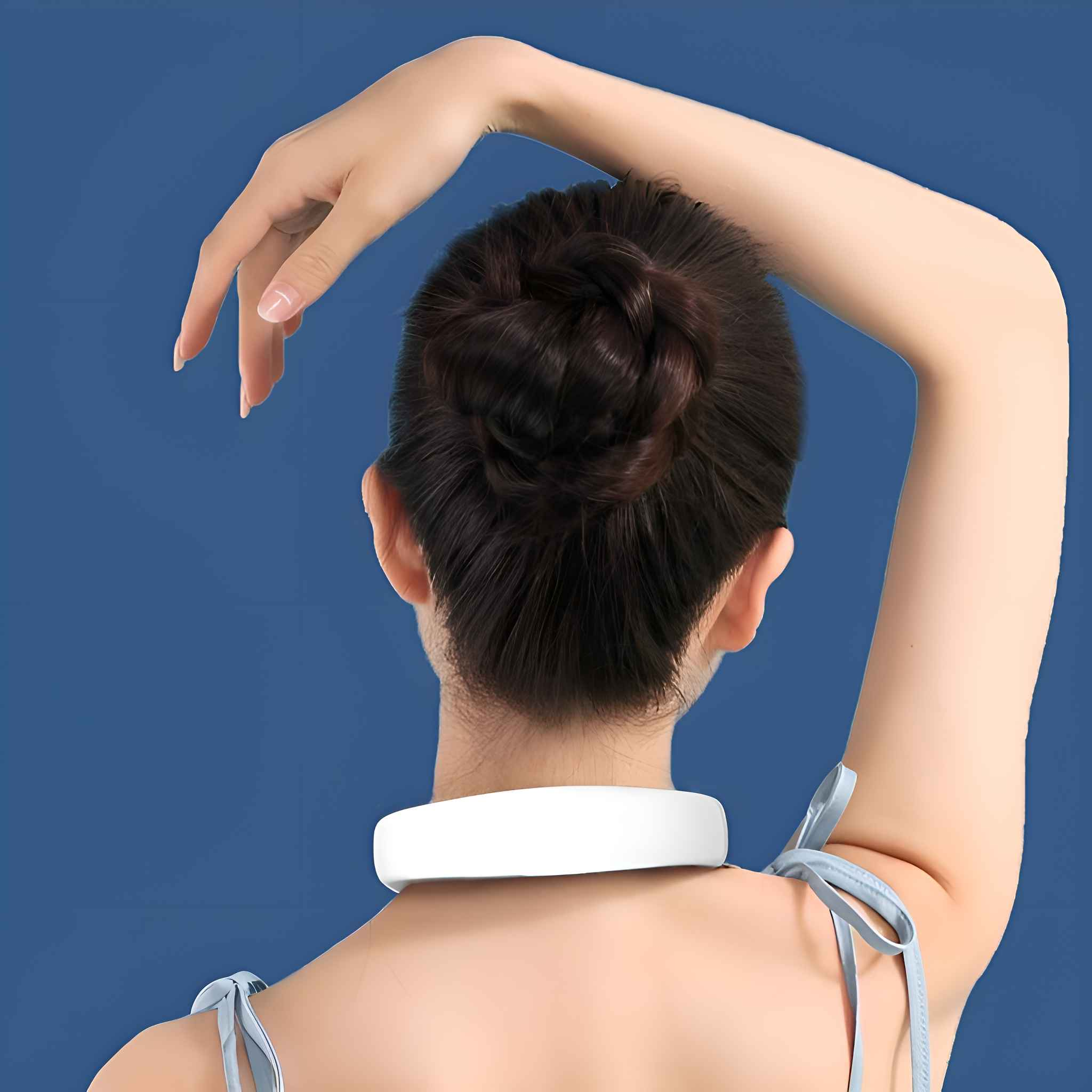 Frau von hinten, die ein weißes Nackenmassagegerät trägt. Ihr Arm ist erhoben.
