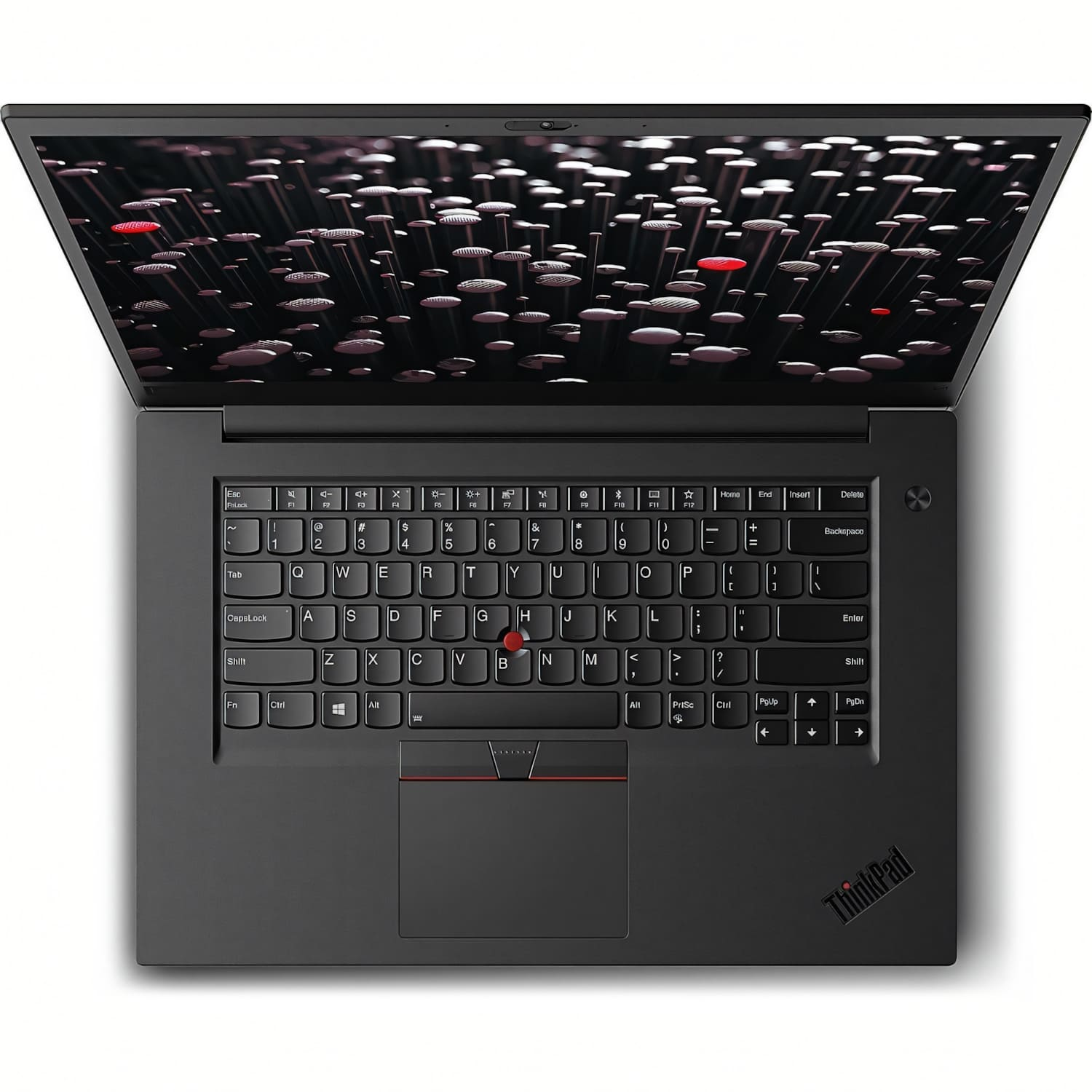 Vista cenital de un teclado de portátil negro con un trackpoint rojo y un fondo rojo en la pantalla.