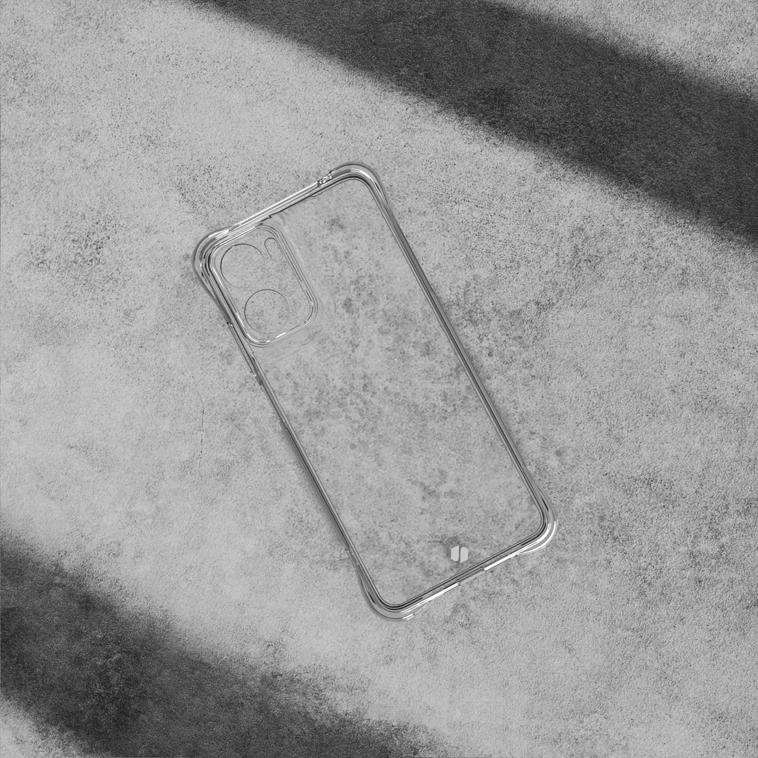 Przezroczyste etui na telefon na szarej, teksturowanej powierzchni. Etui jest puste i rzuca cień.