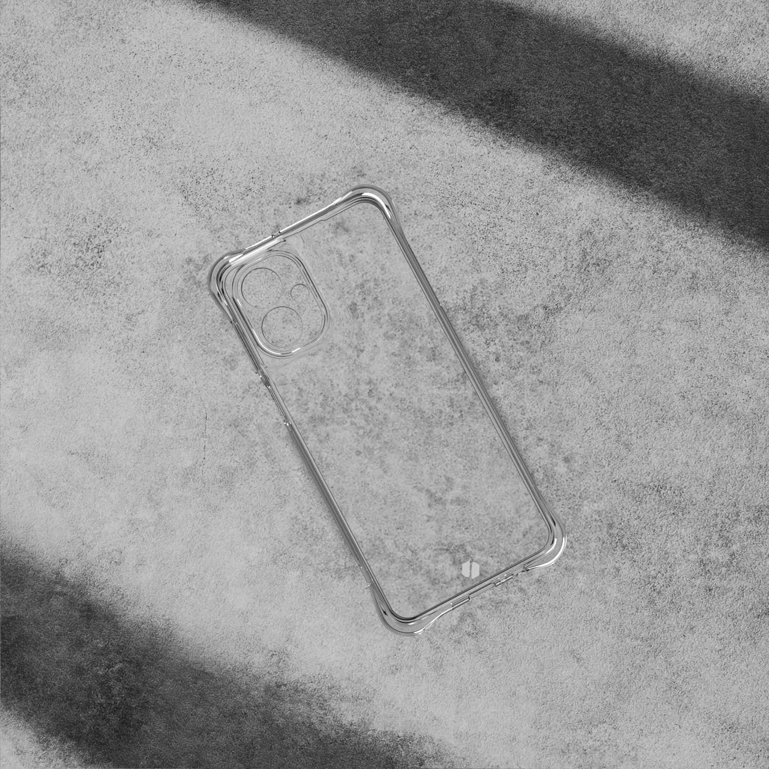 Przezroczyste etui na telefon na szarej powierzchni. Etui ma prostokątny kształt. Powierzchnia ma cętkowaną fakturę.