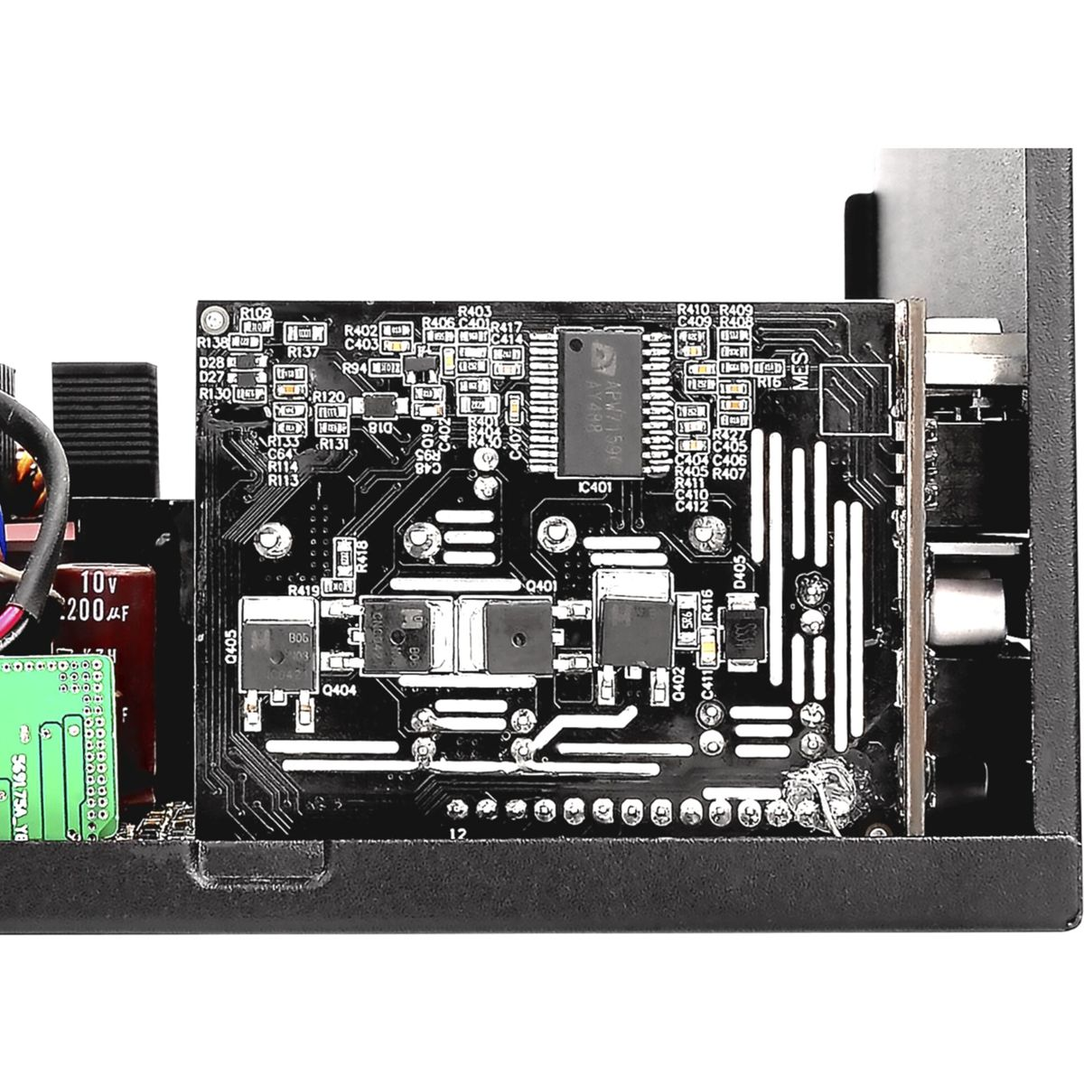 Zbliżenie płytki obwodu w zasilaczu, z różnymi komponentami elektronicznymi.