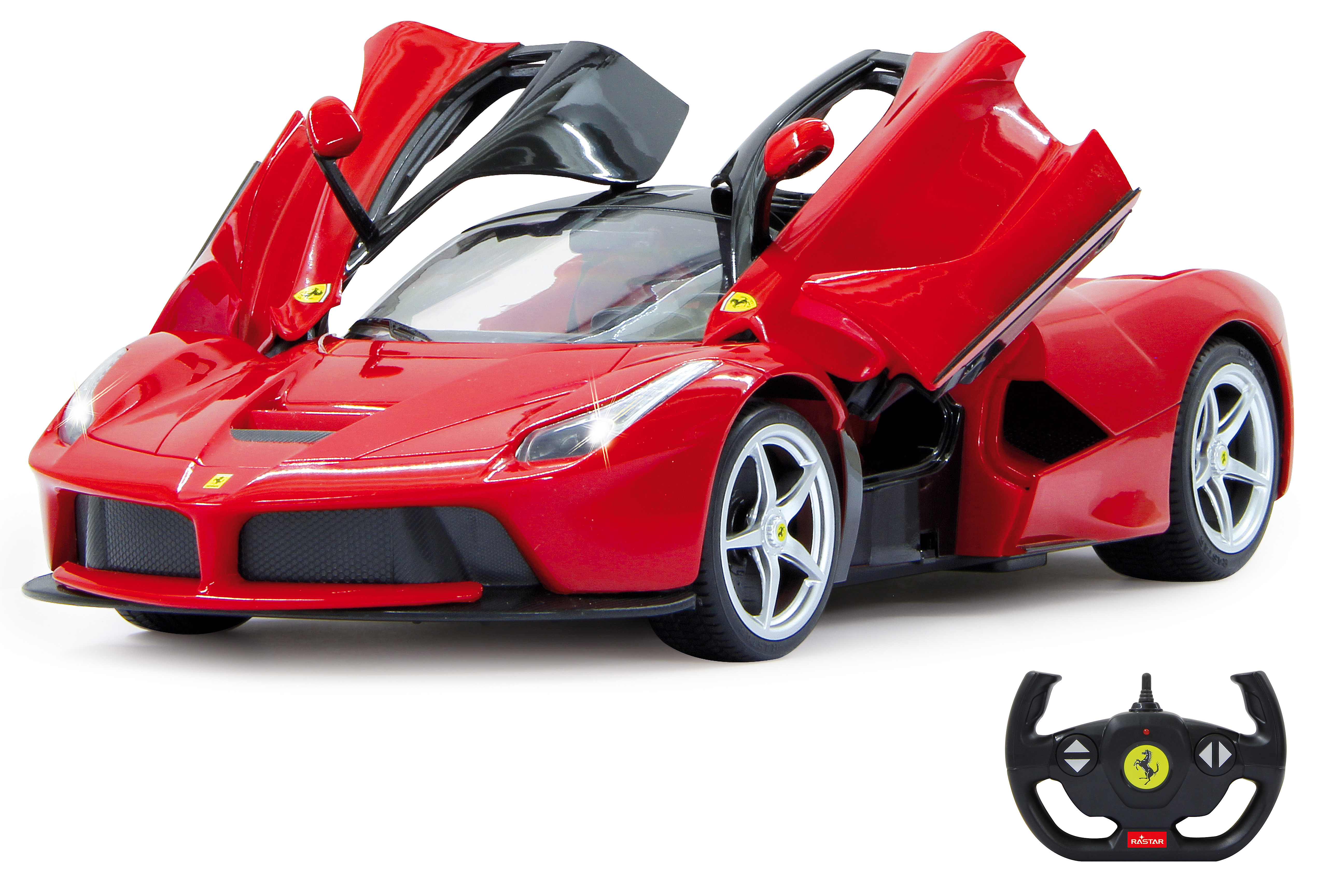 A red Ferrari model car with open doors and a remote control on a white surface.