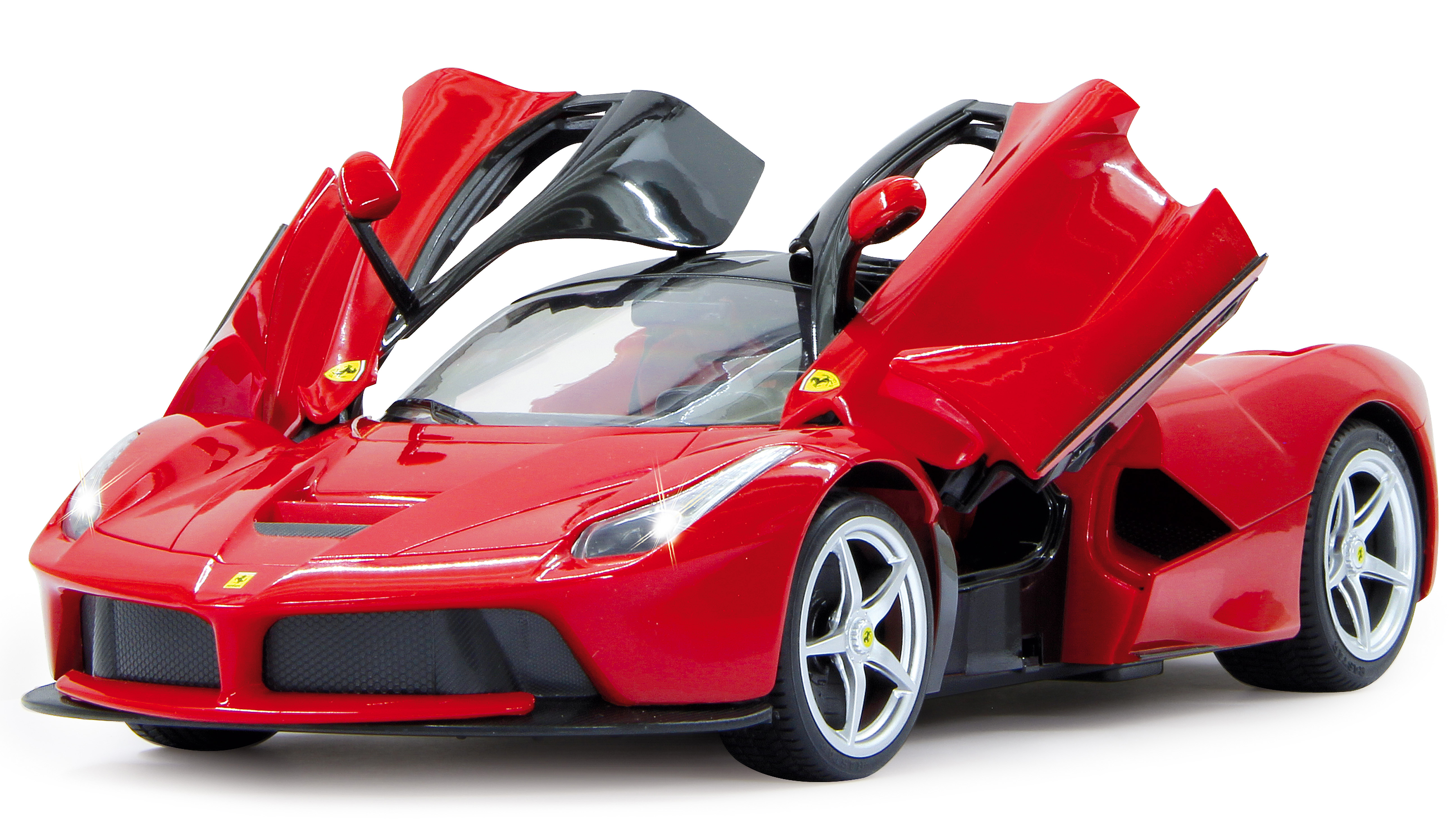 A red Ferrari model car with open doors on a white surface.